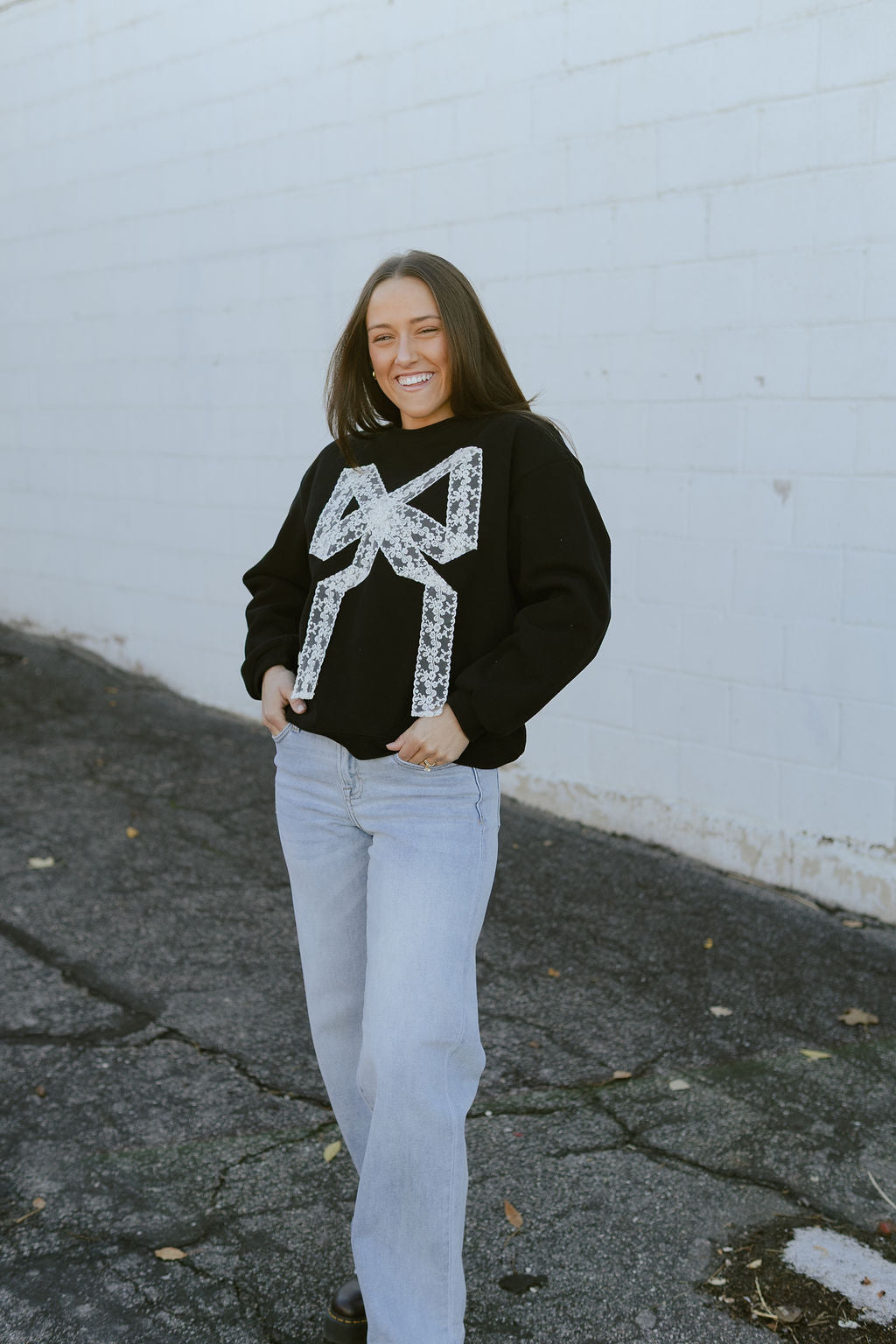 black sweatshirt with white lace bow on the front