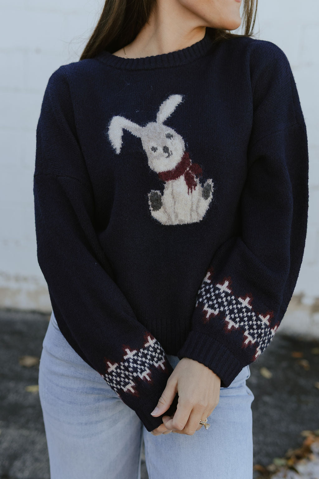 navy blue sweater with bunny print on the front