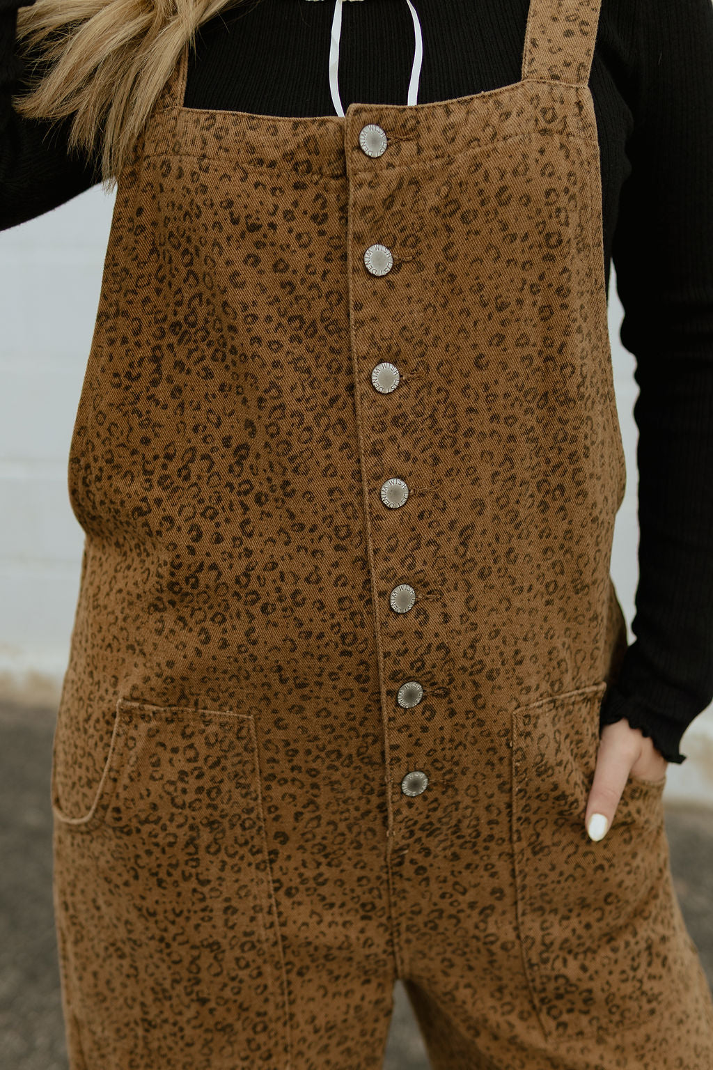 Overalls with a slight cheetah print and buttons up the front