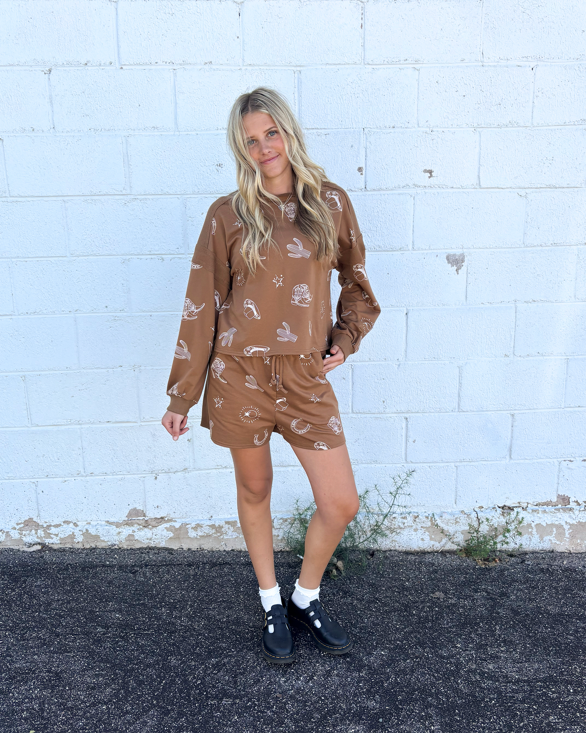 Brown outfit set with sweater top and shorts and cowboy icons all over
