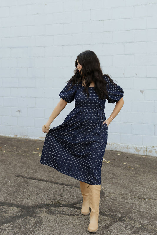 Indigo denim dress with white floral embroidery and puff sleeves