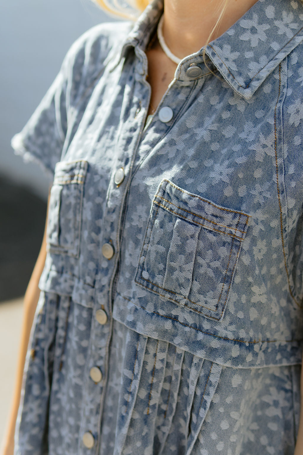 Denim a-line dress with light colored floral pattern