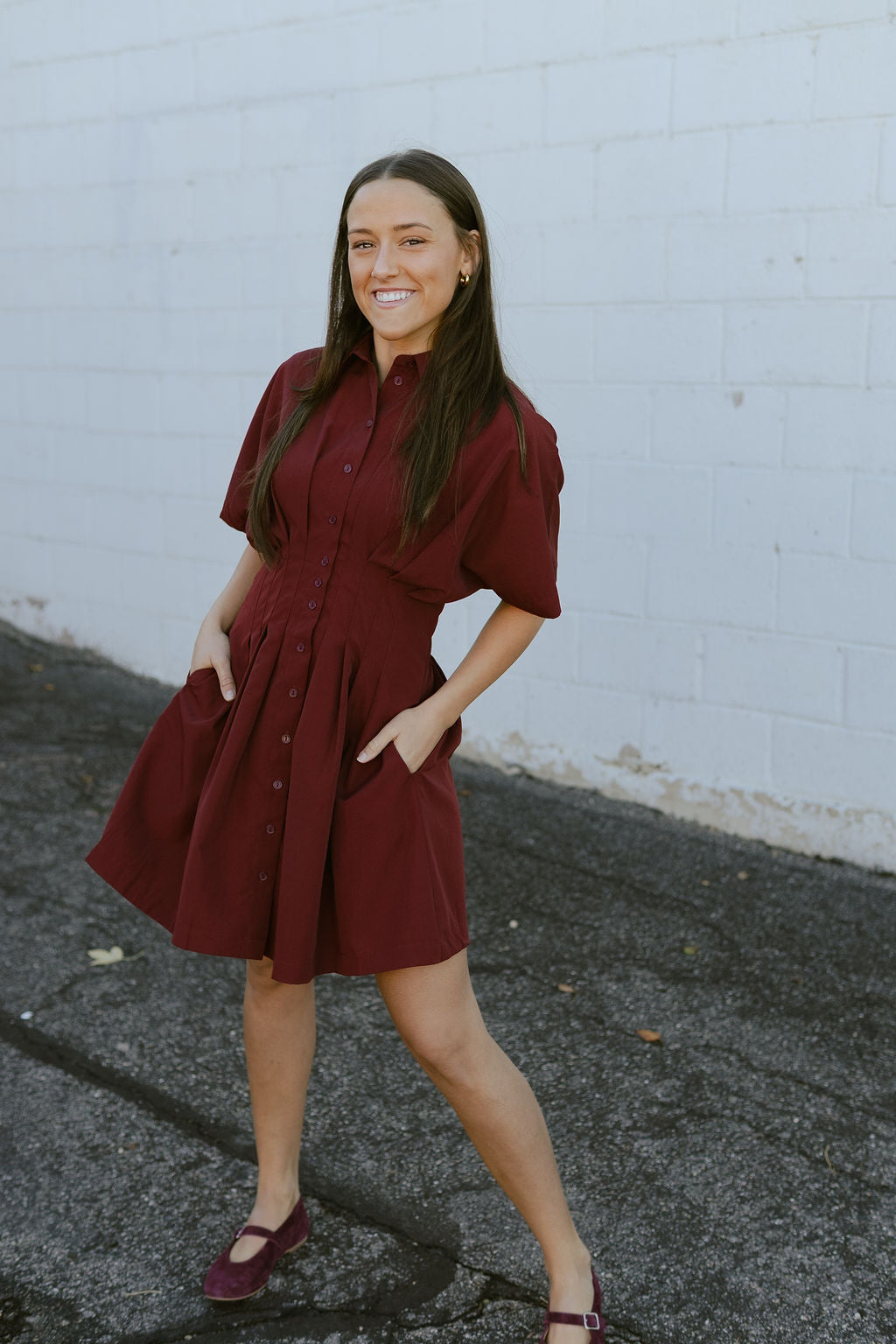 Dark red dress with knife pleats along the front and buttons up the front