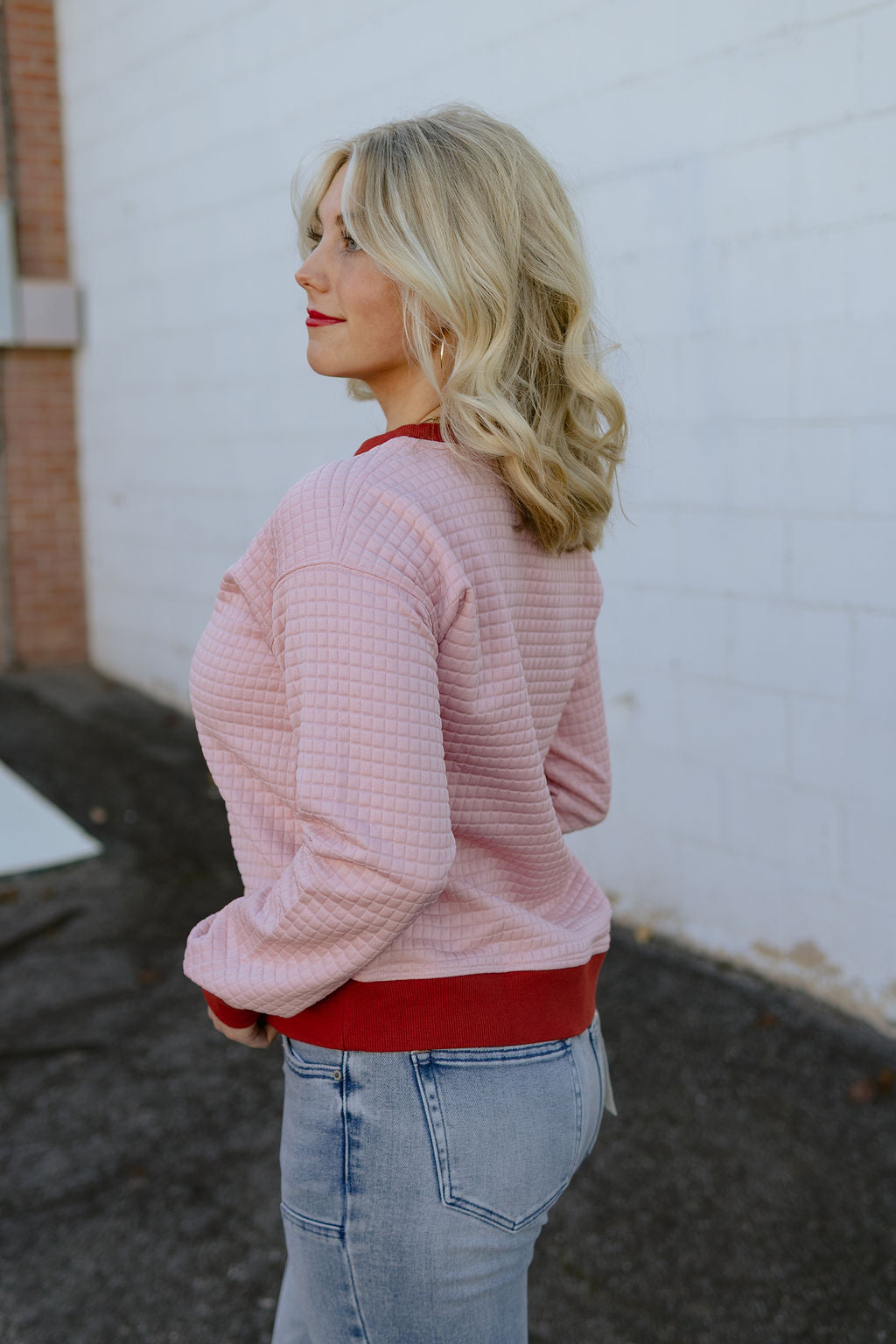 pink quilted sweater with maroon trim