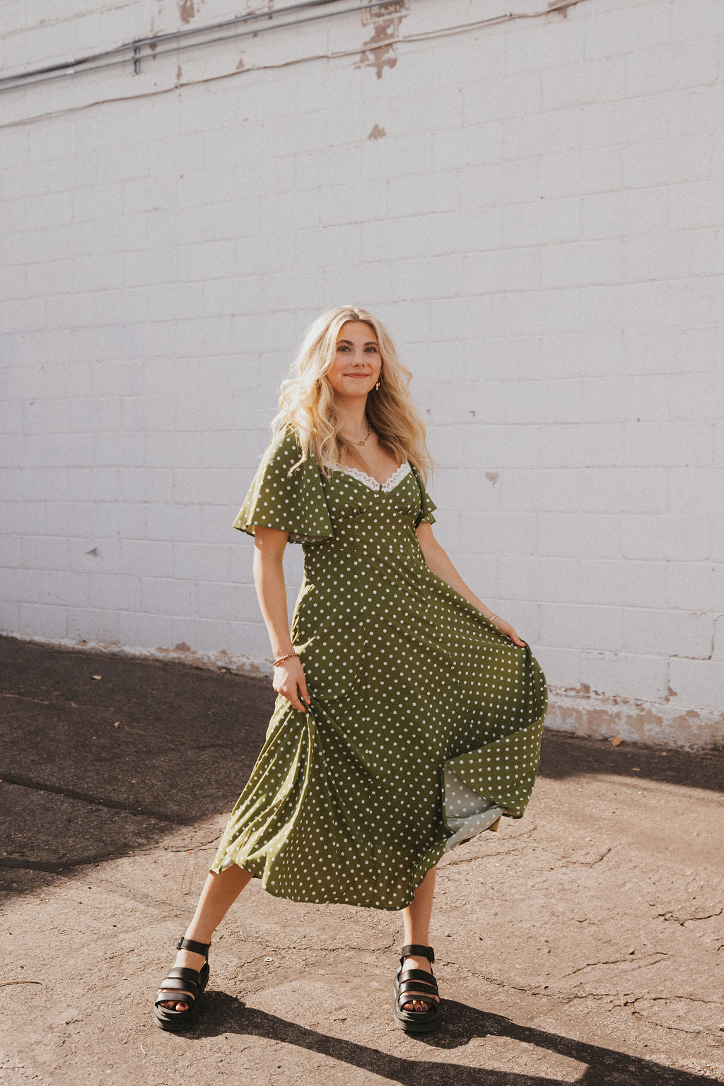 olive green dress with white polka dots and lace trim