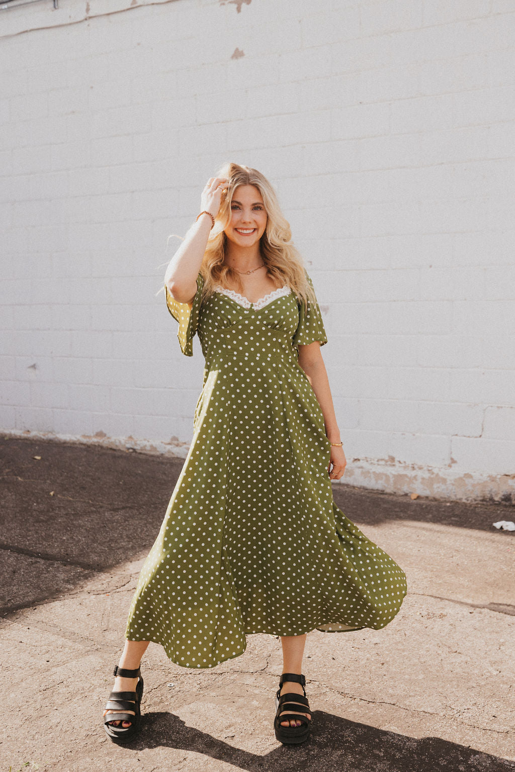 olive green dress with white polka dots and lace trim
