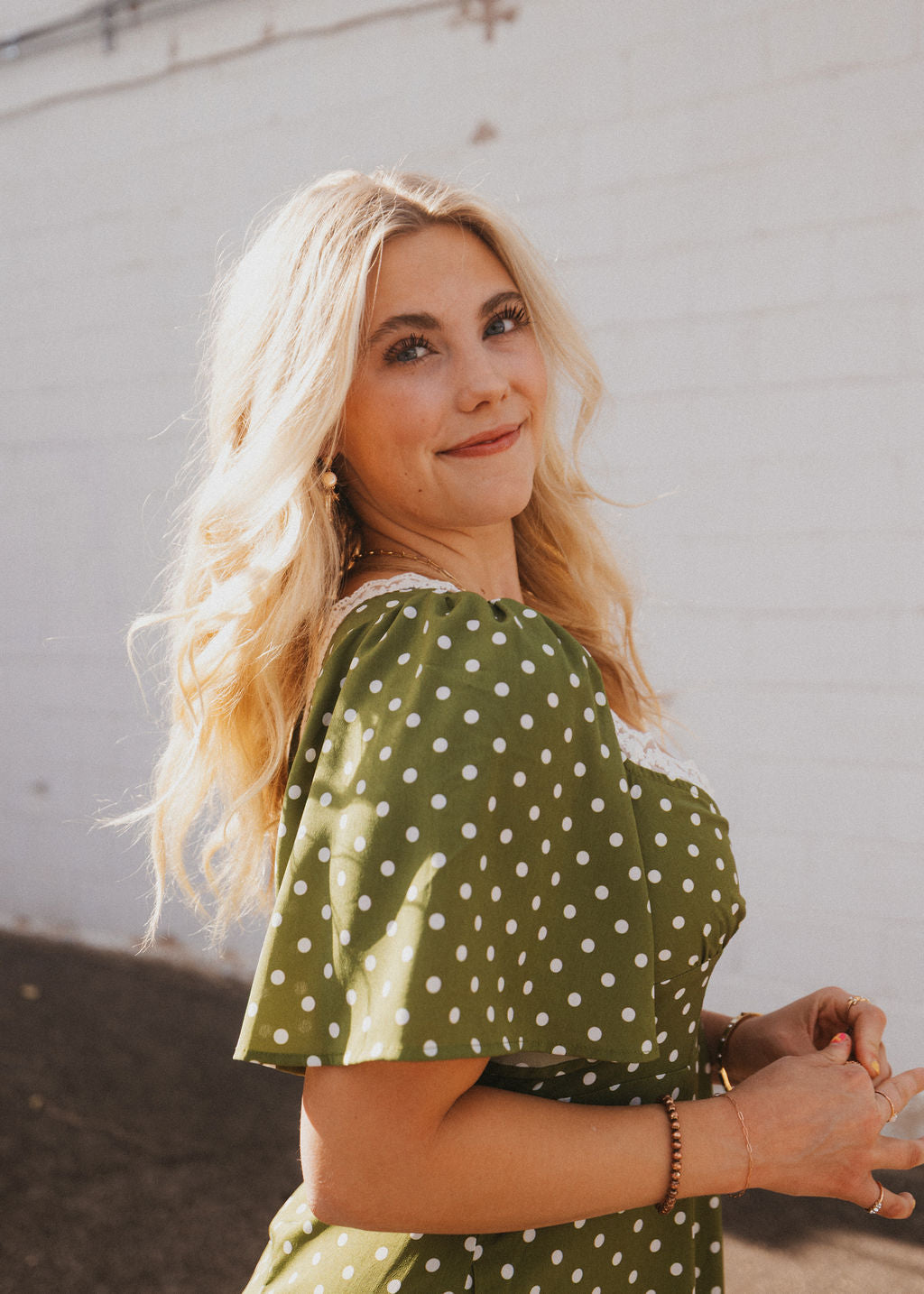 olive green dress with white polka dots and lace trim