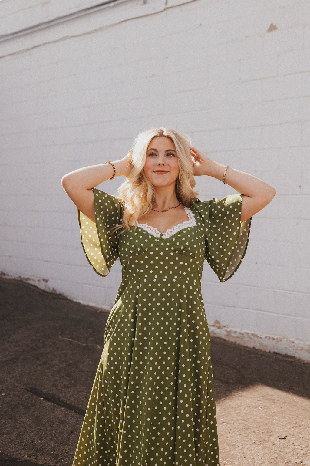 olive green dress with white polka dots and lace trim