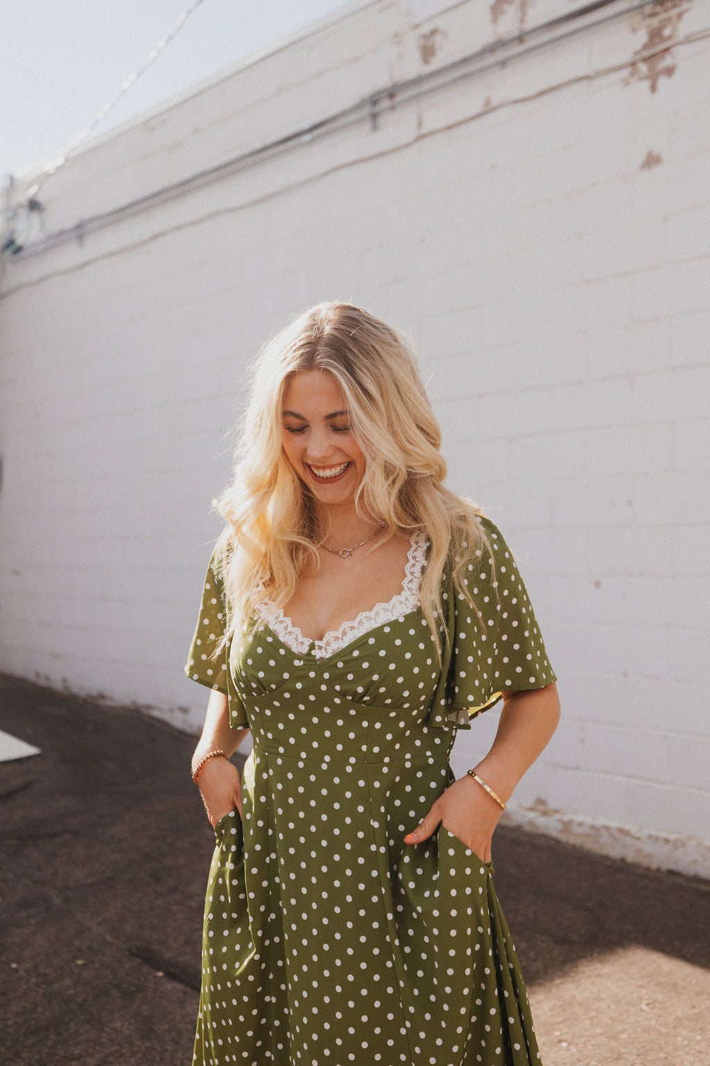 olive green dress with white polka dots and lace trim