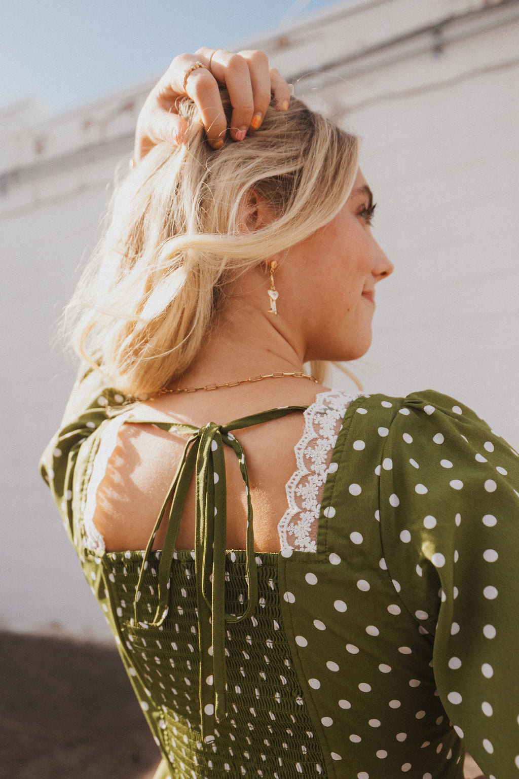 olive green dress with white polka dots and lace trim
