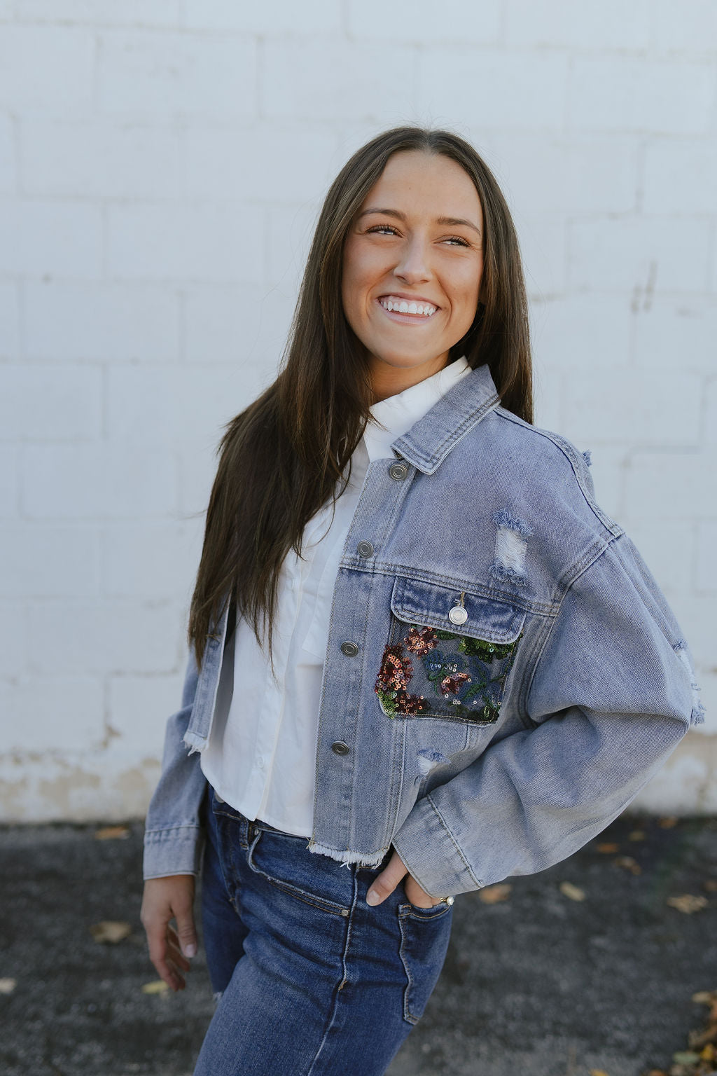 jean jacket with a cutout on the back and filled with lace and sequins