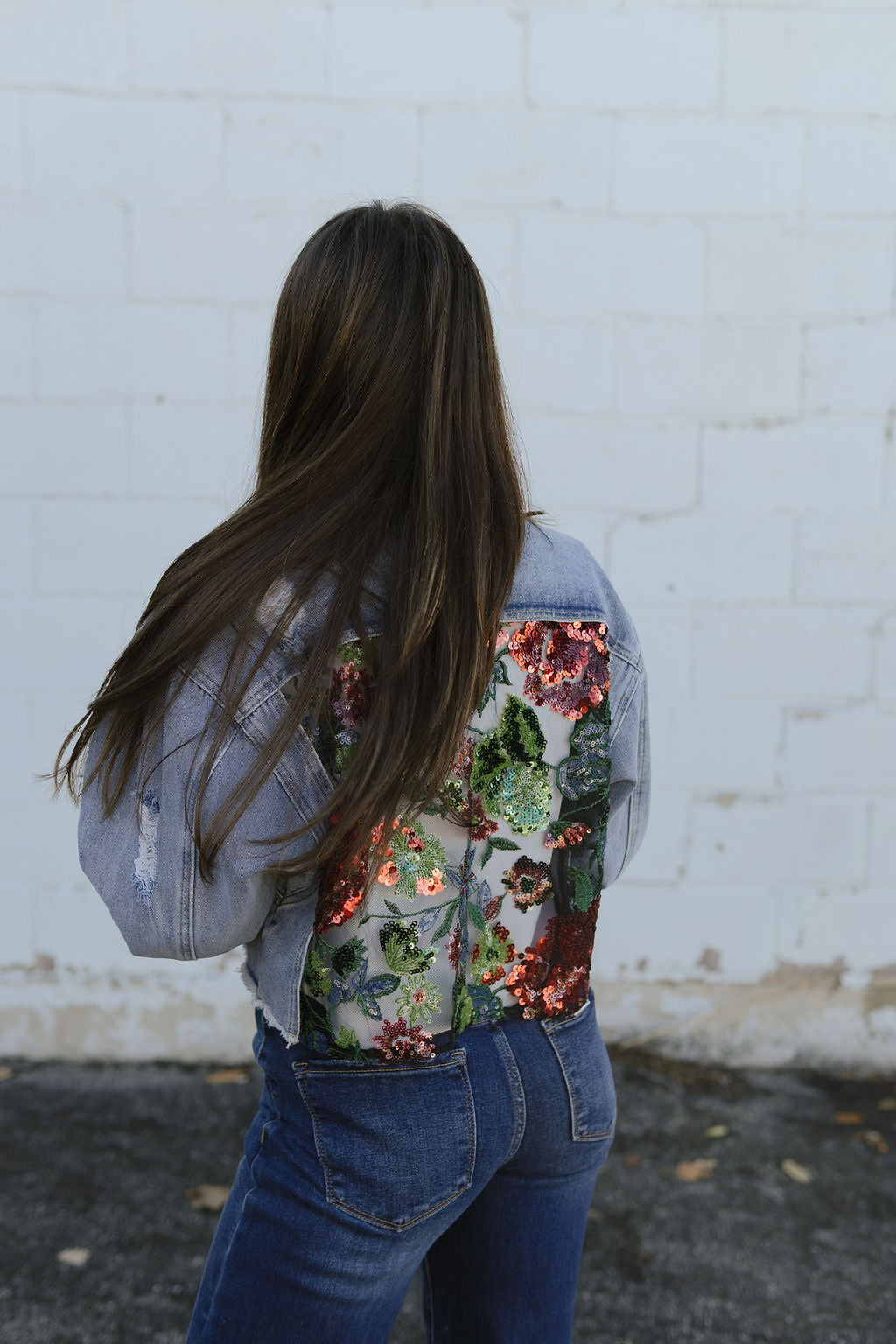 jean jacket with a cutout on the back and filled with lace and sequins