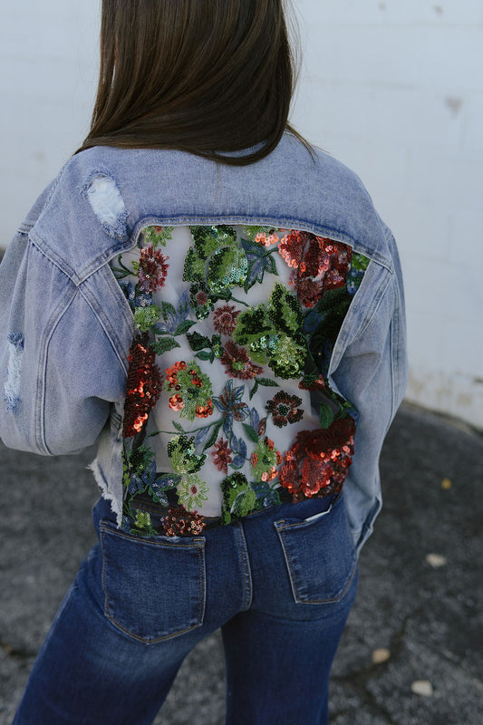 jean jacket with a cutout on the back and filled with lace and sequins