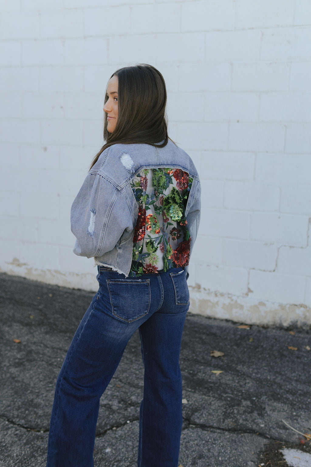 jean jacket with a cutout on the back and filled with lace and sequins