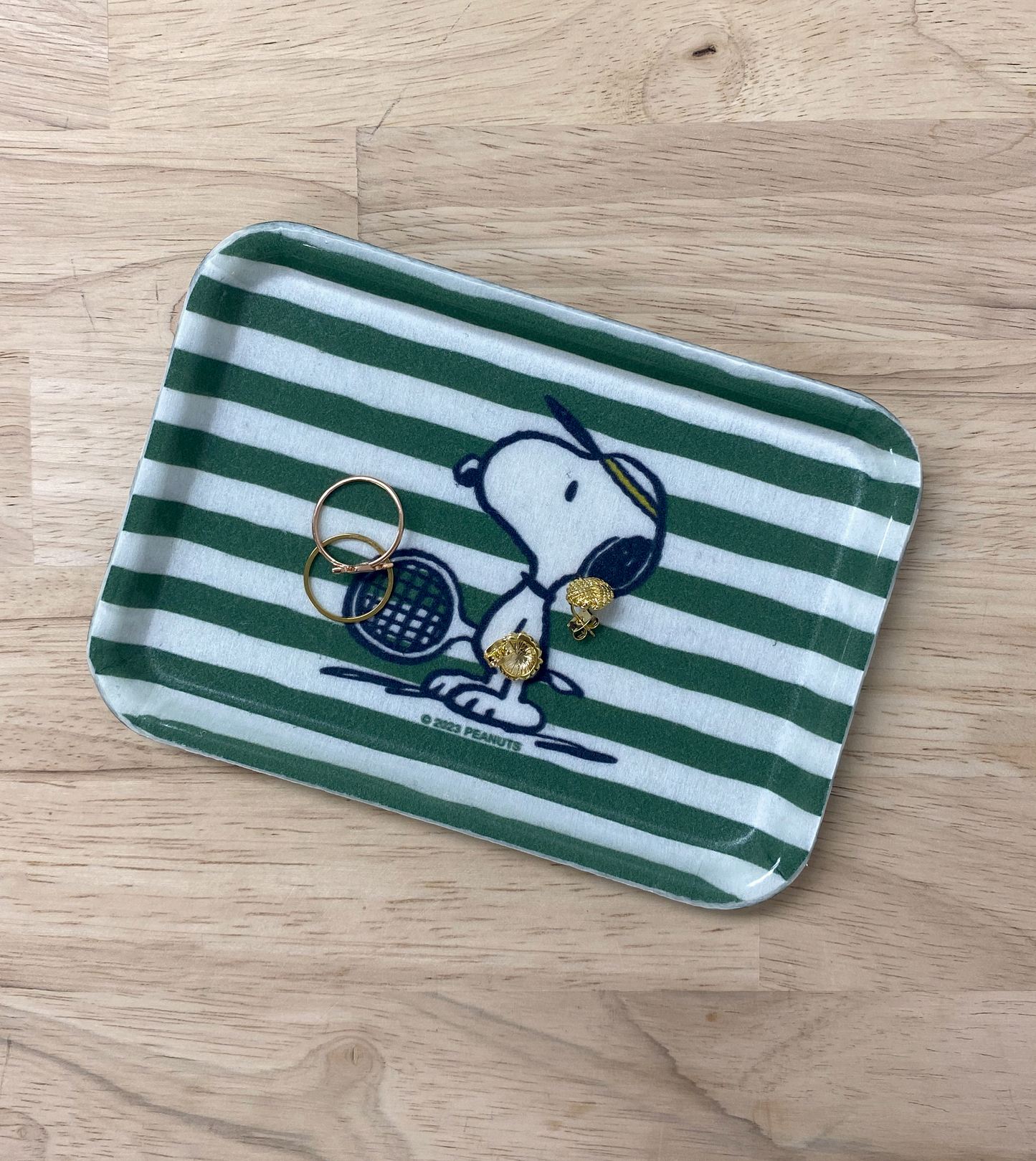 Trinket dish with stripes and Snoopy playing tennis