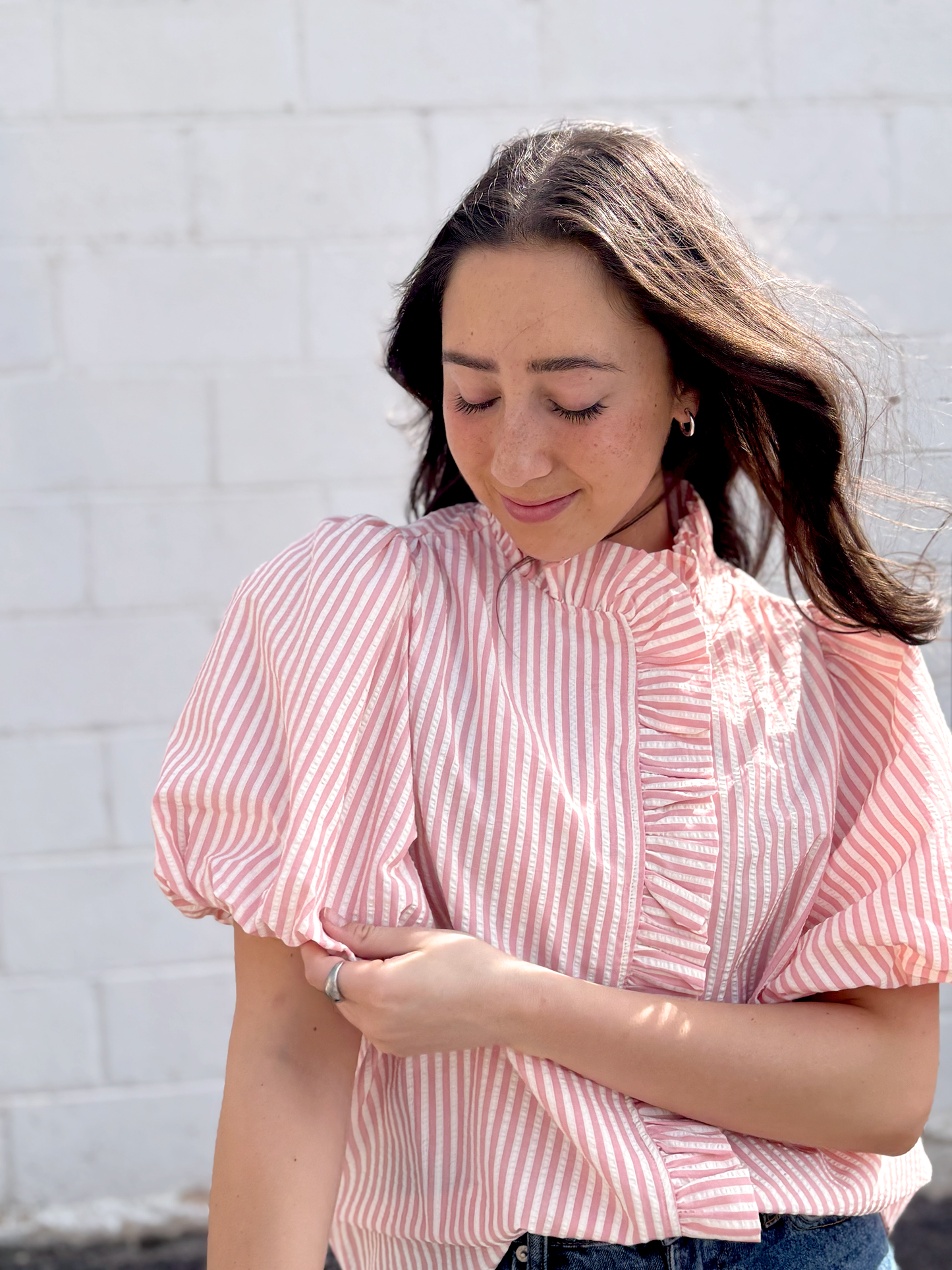 Pink striped button up top with puff sleeves and ruffles up the front and collar