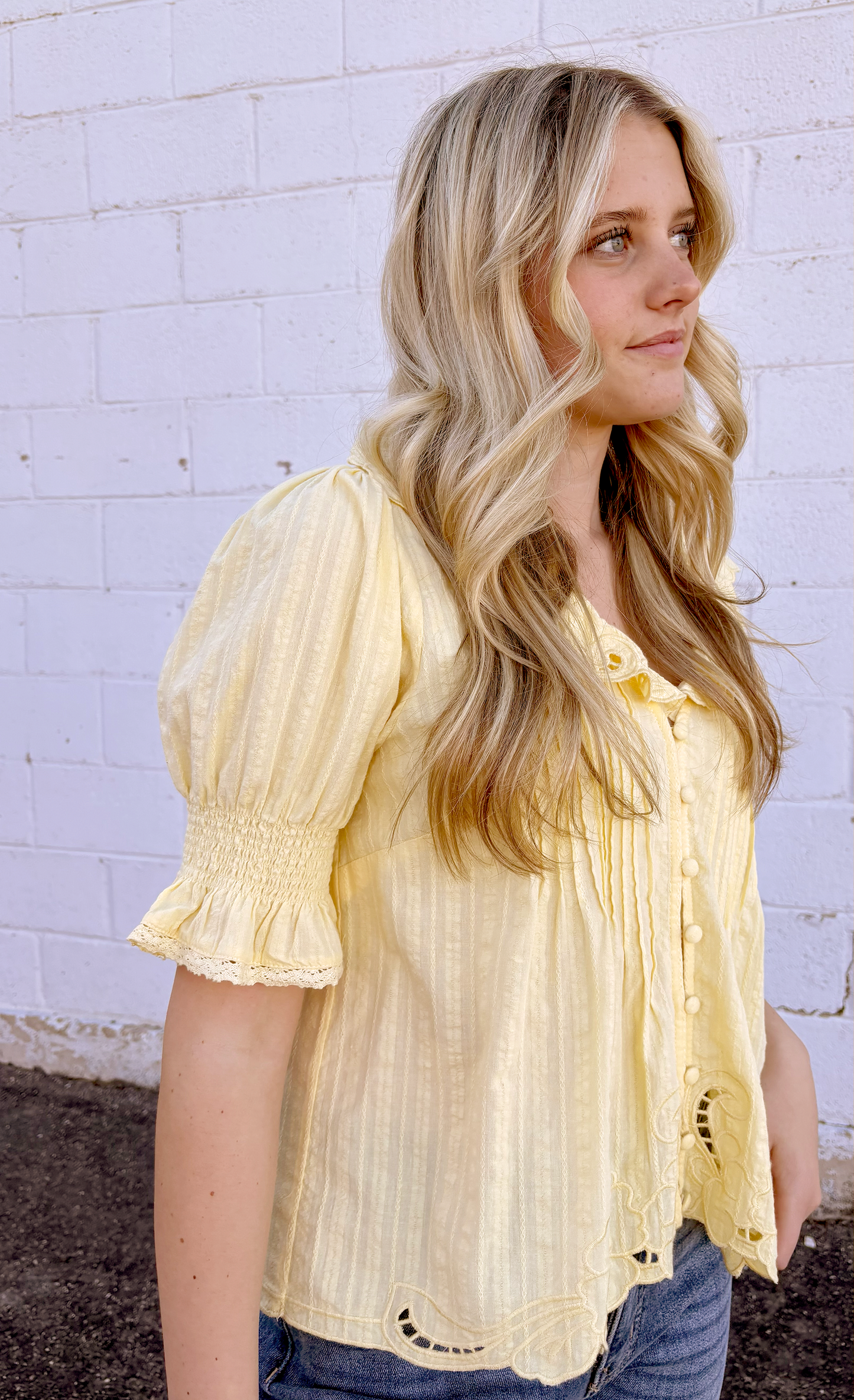 Yellow top with puff sleeves and embroidered embellishments