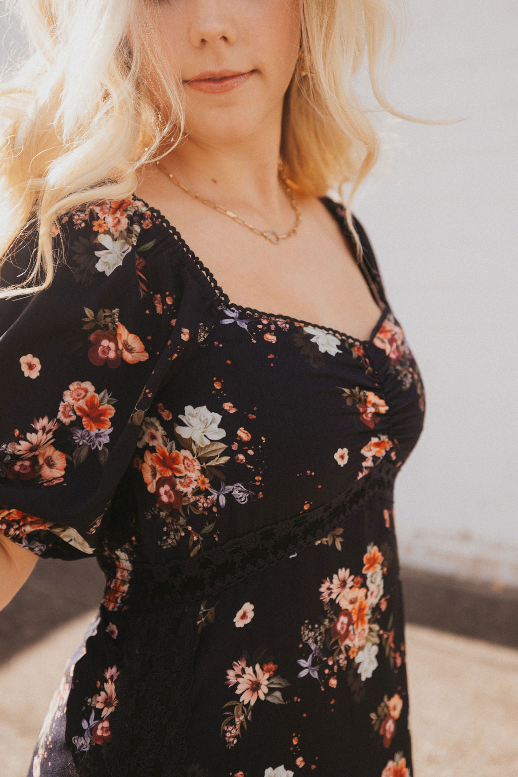 black dress with fall floral pattern and black lace trim