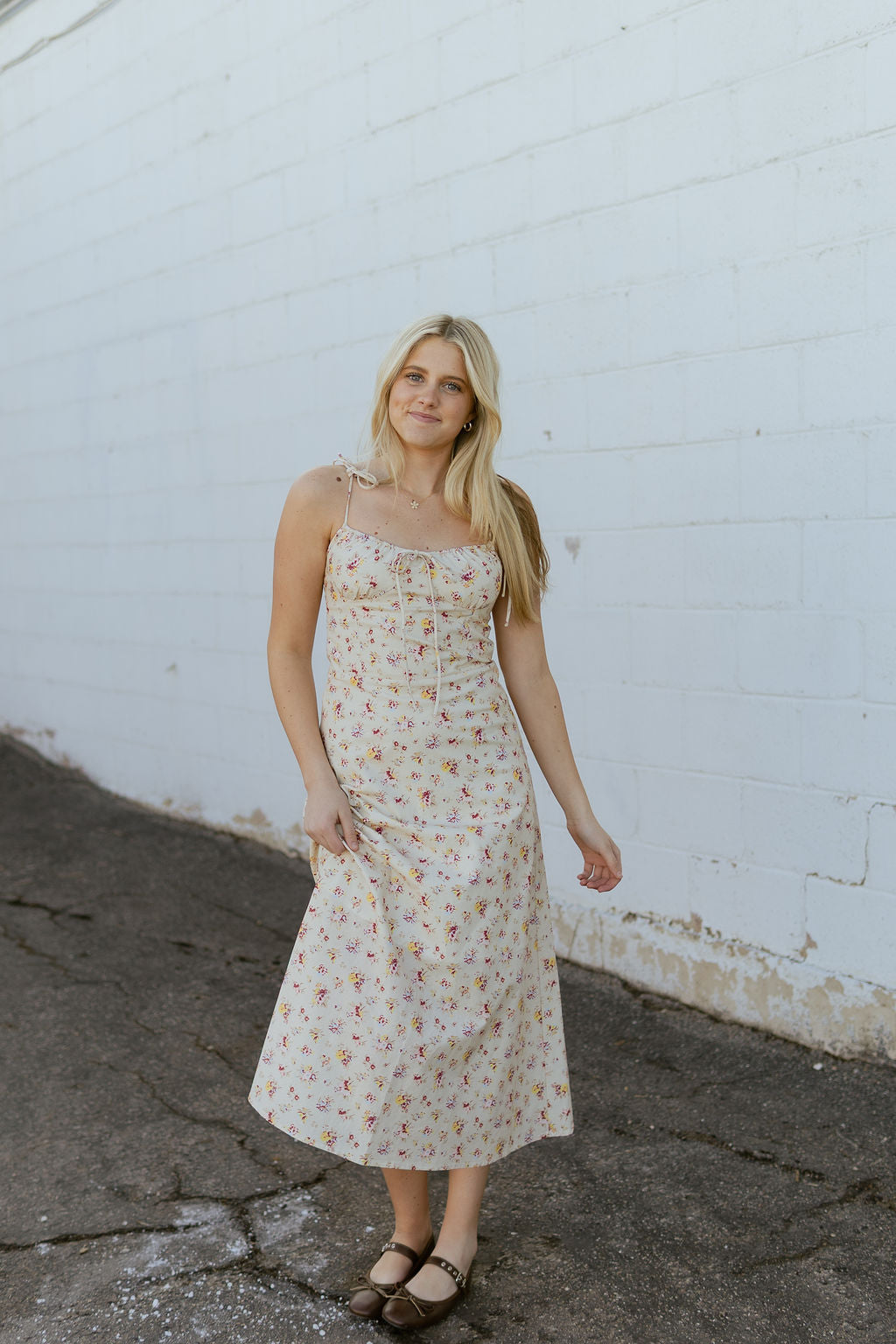 beige dress with red and yellow flower print