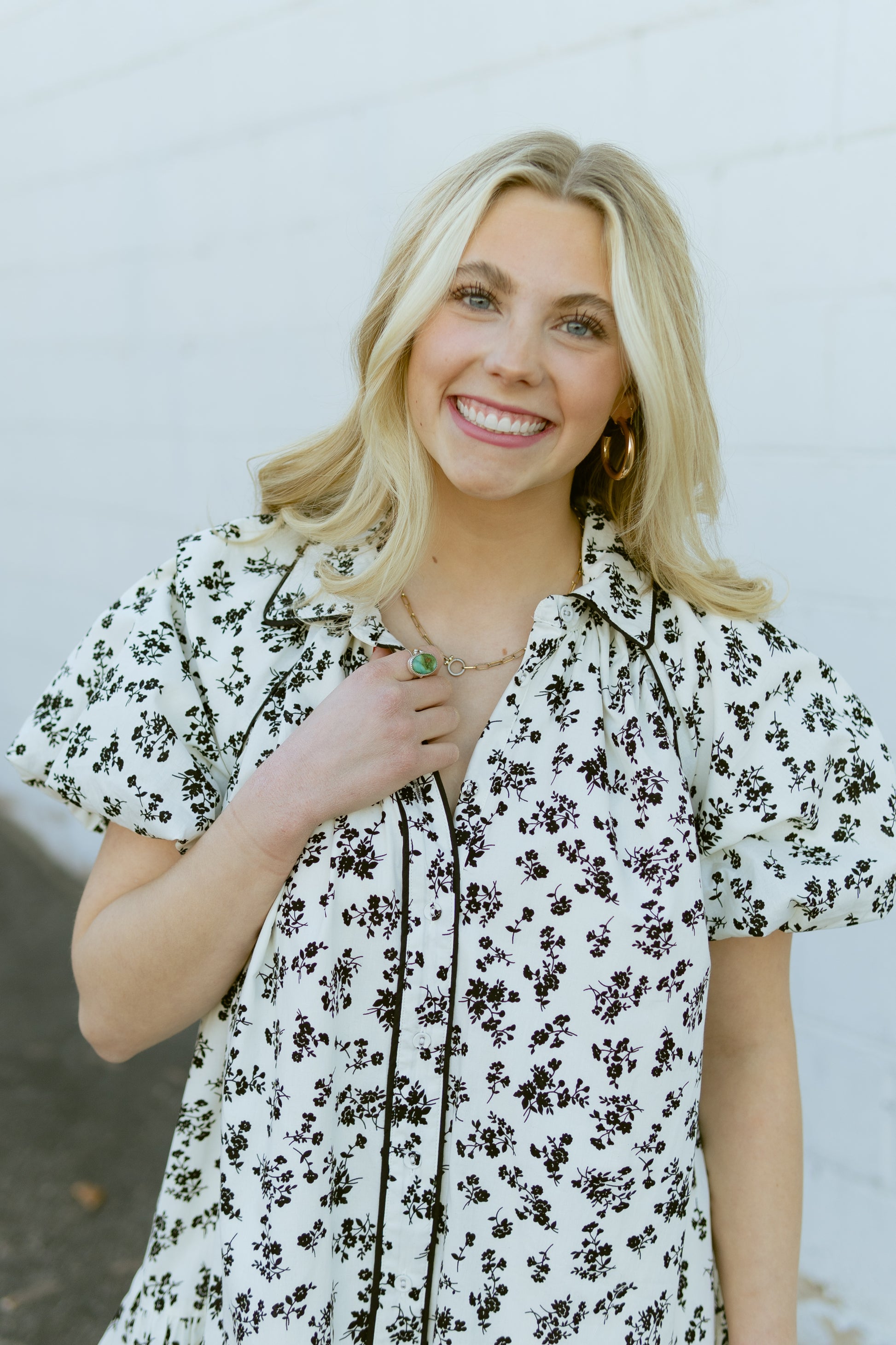 white a-line mini dress with black floral pattern