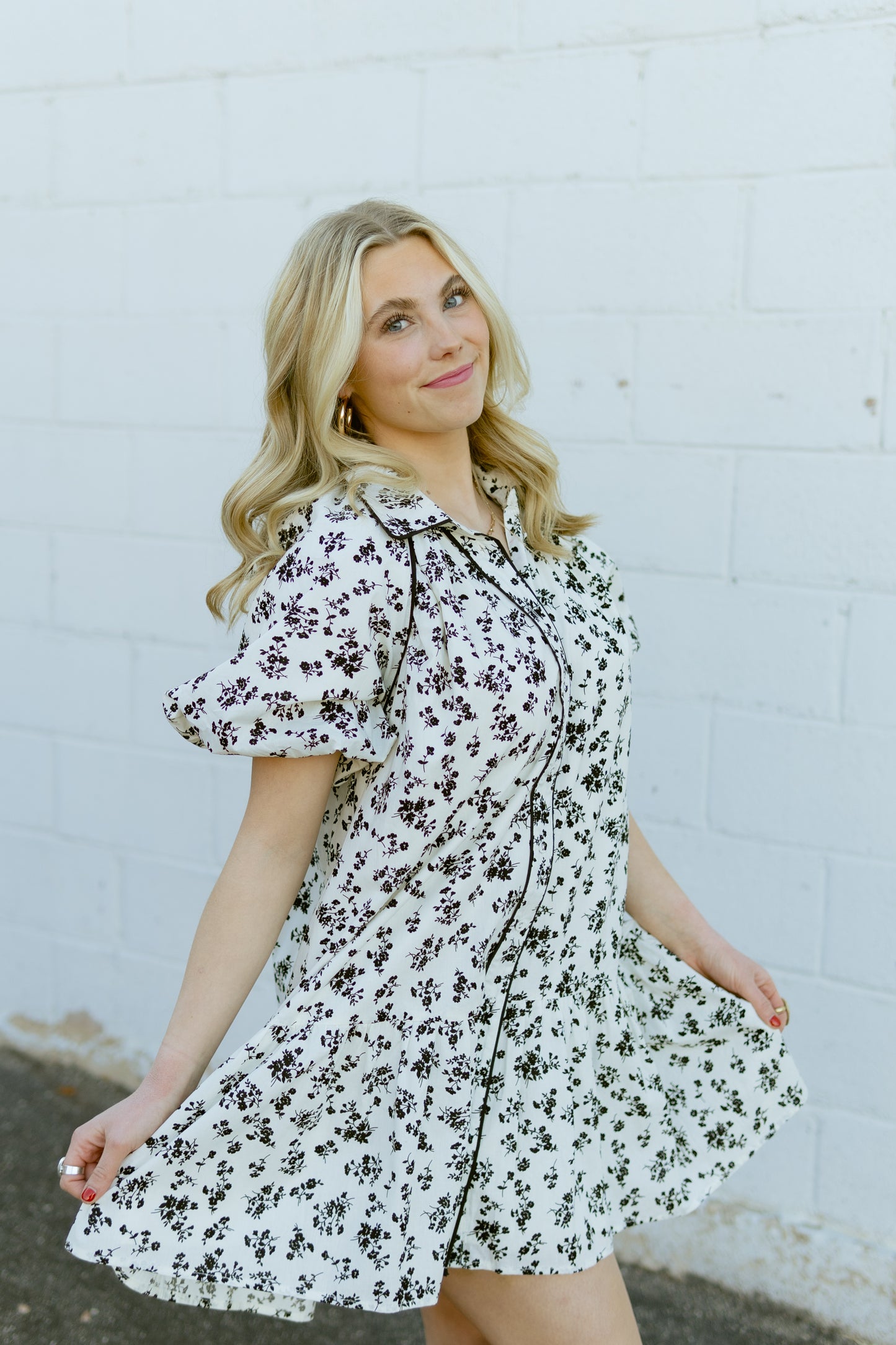 white a-line mini dress with black floral pattern