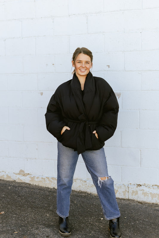 Black fitted puffer jacket with tie at the waist