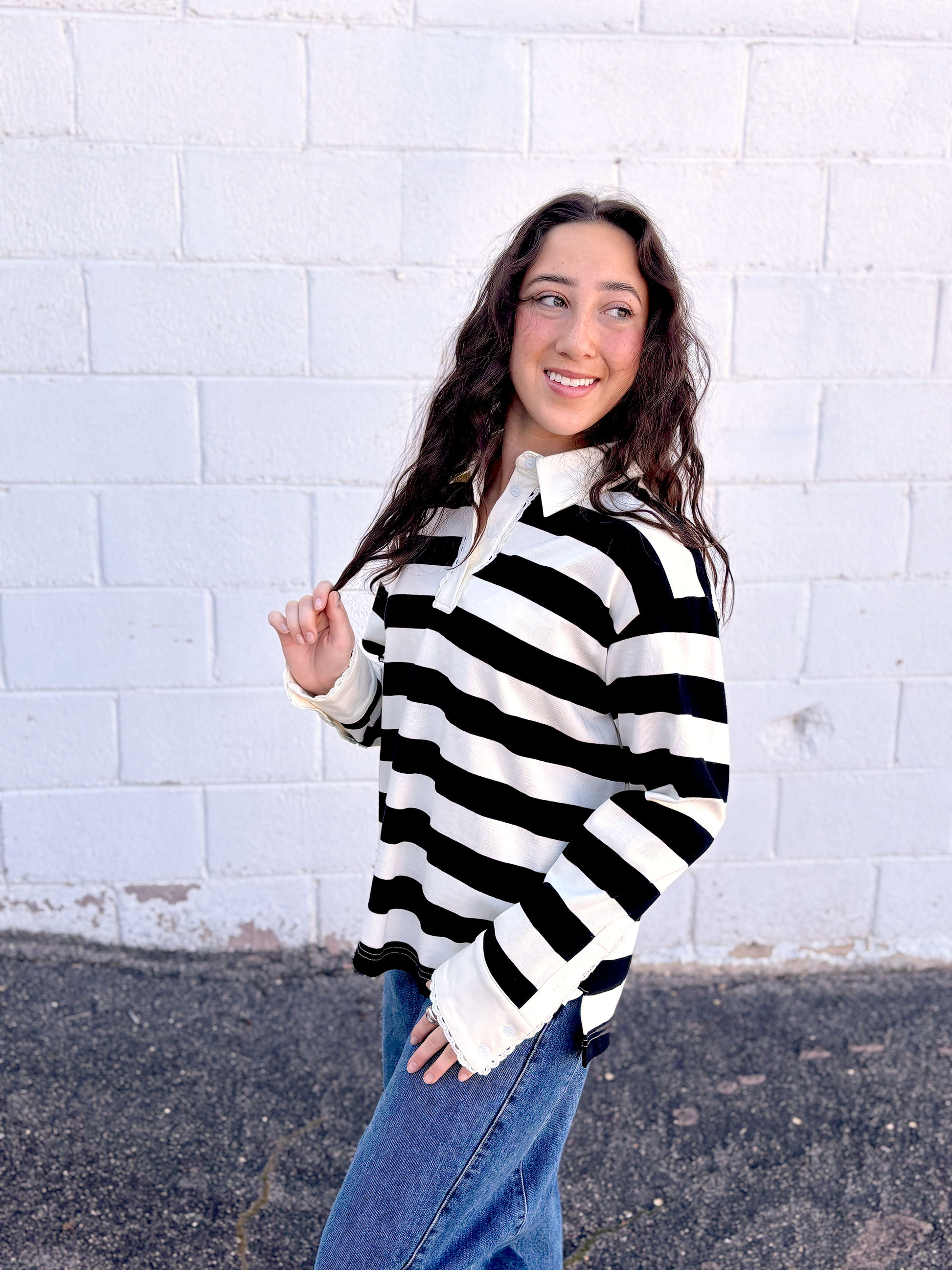 black and white striped top with long sleeves and delicate lace details around the neckline and cuffs