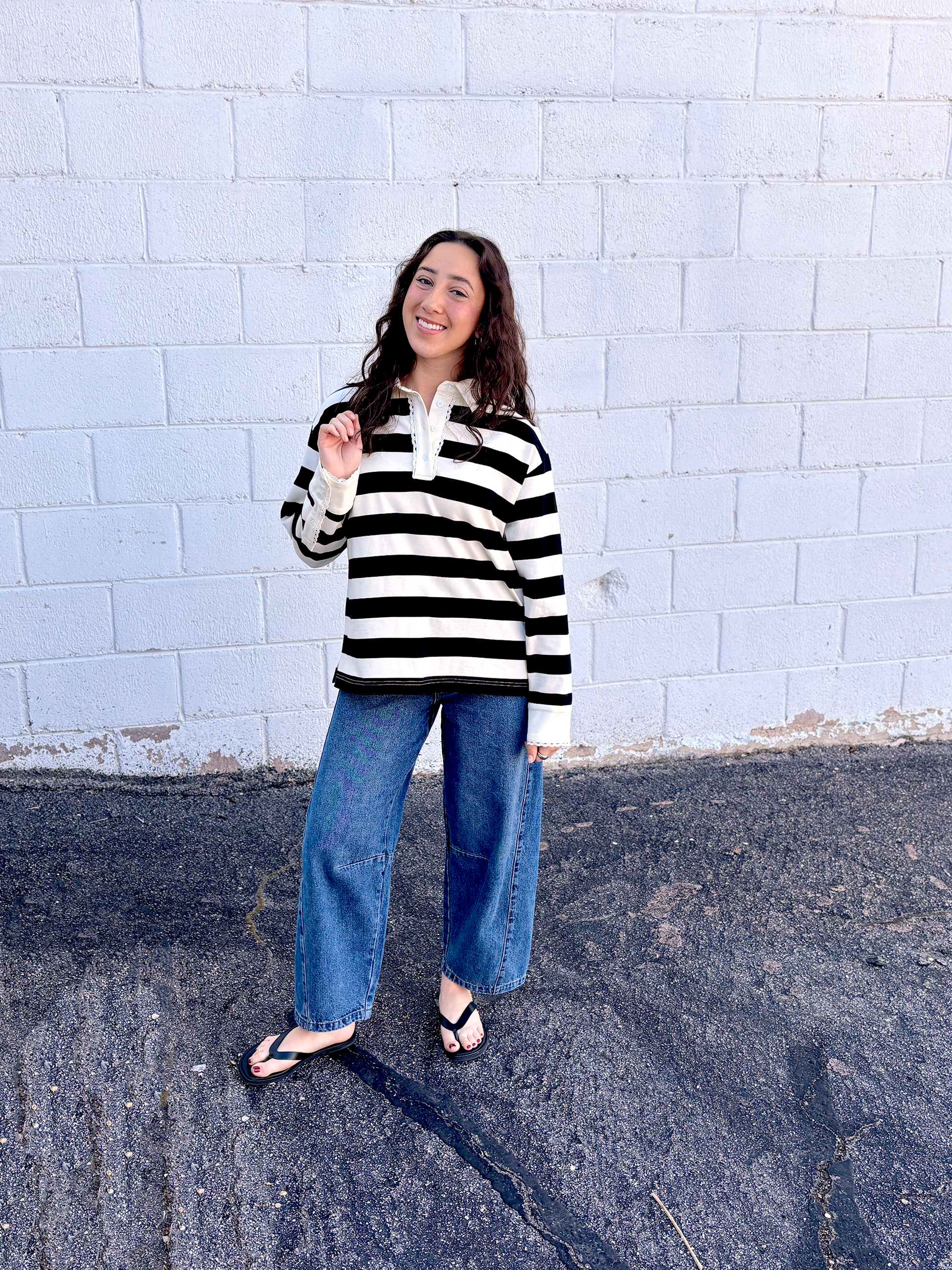black and white striped top with long sleeves and delicate lace details around the neckline and cuffs