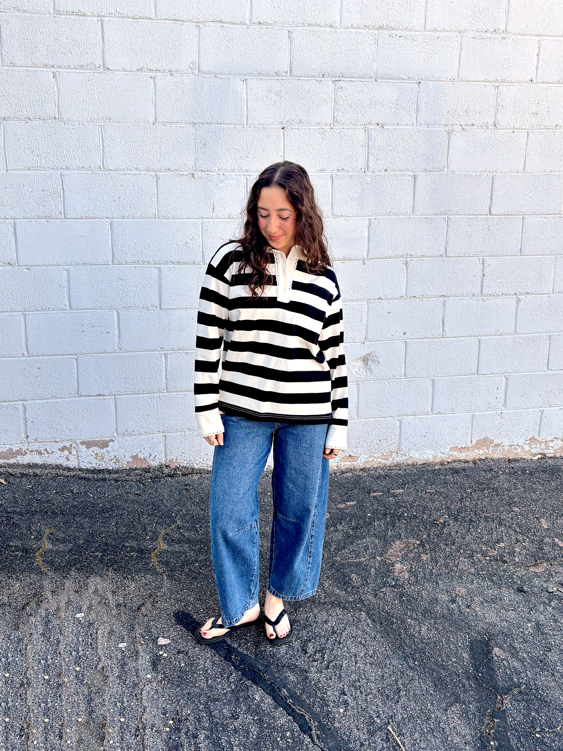 black and white striped top with long sleeves and delicate lace details around the neckline and cuffs