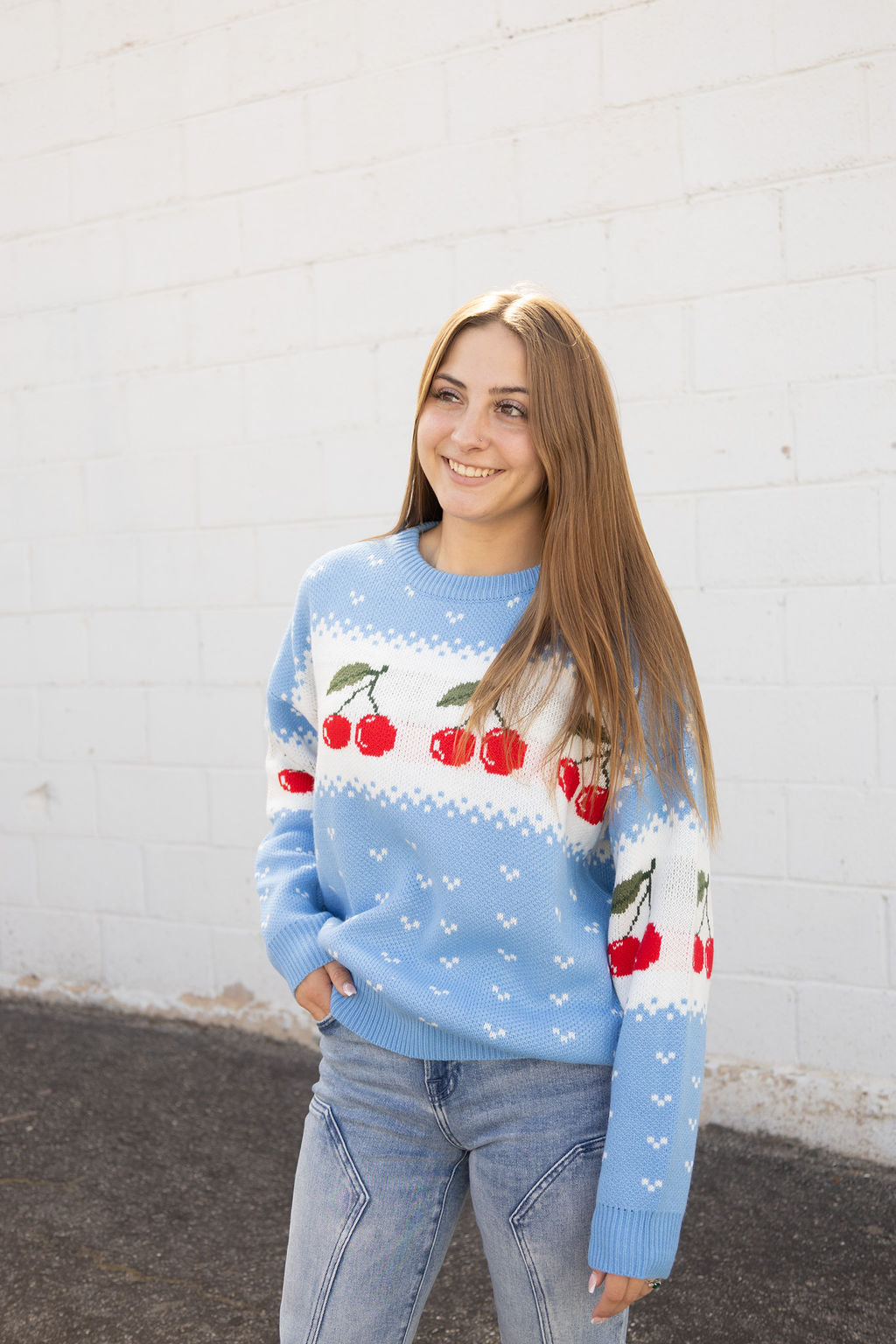 Blue knit sweater with cherry pattern