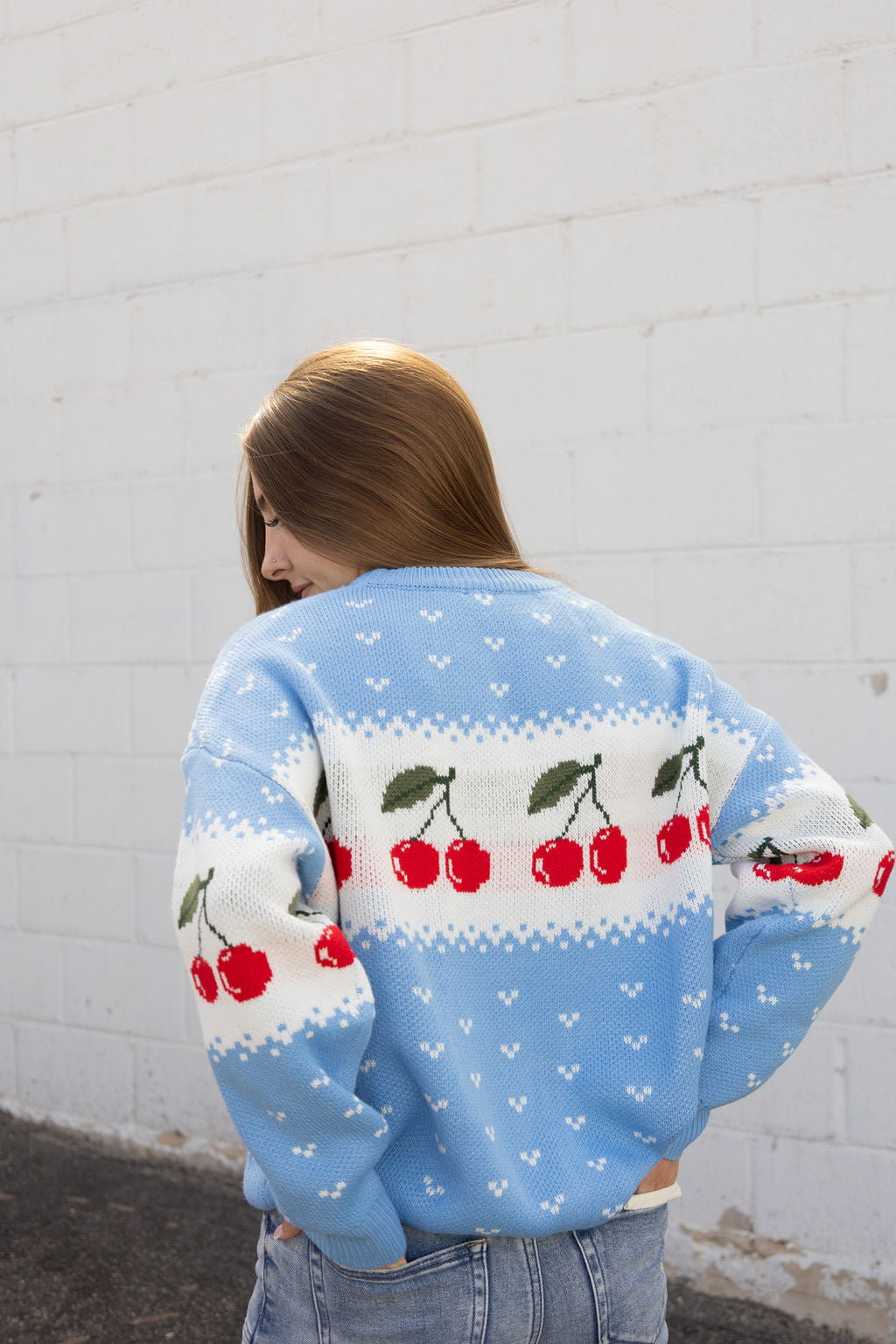 Blue knit sweater with cherry pattern
