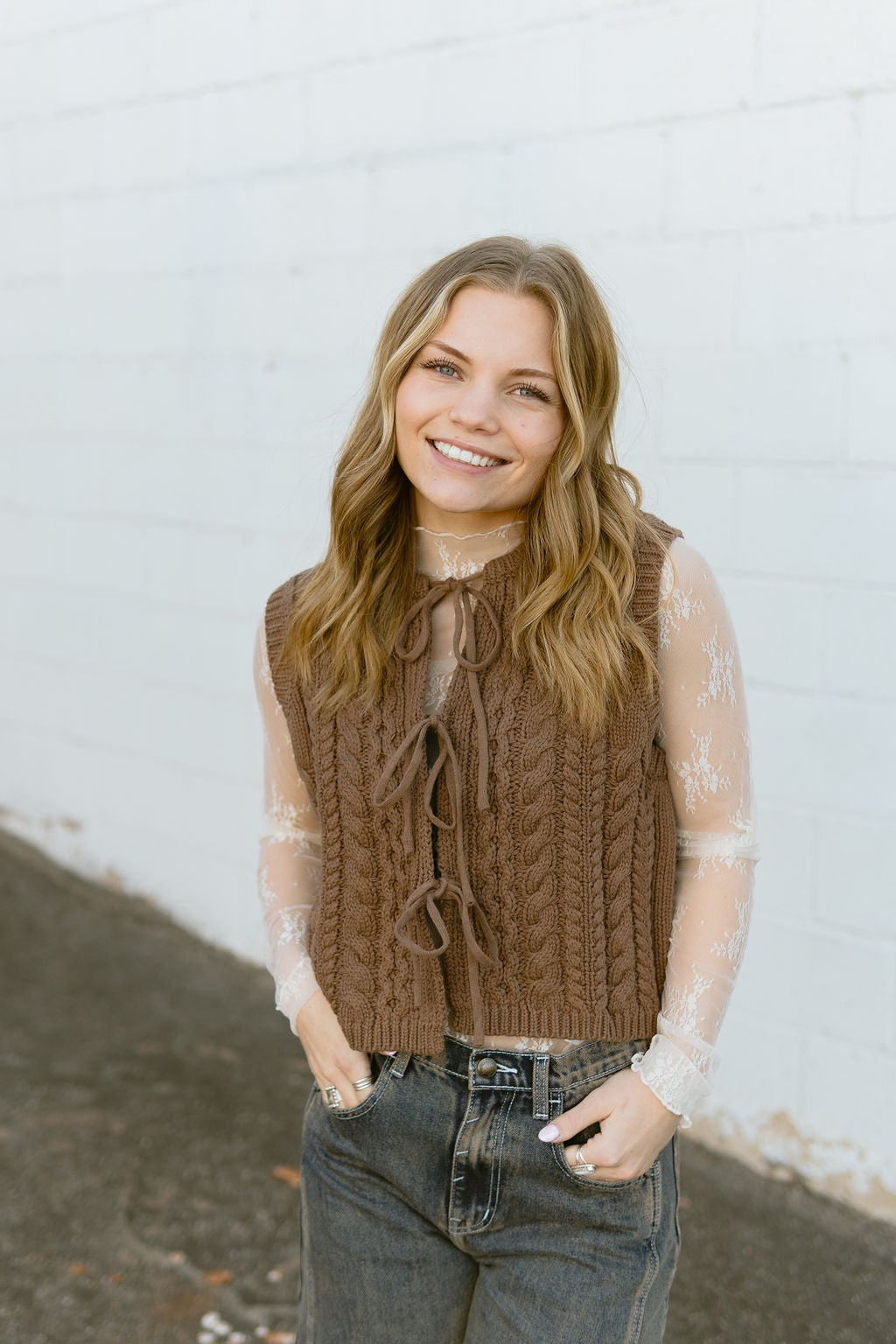 brown knit vest with bow ties down front