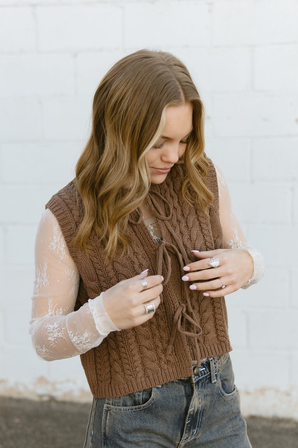 brown knit vest with bow ties down front