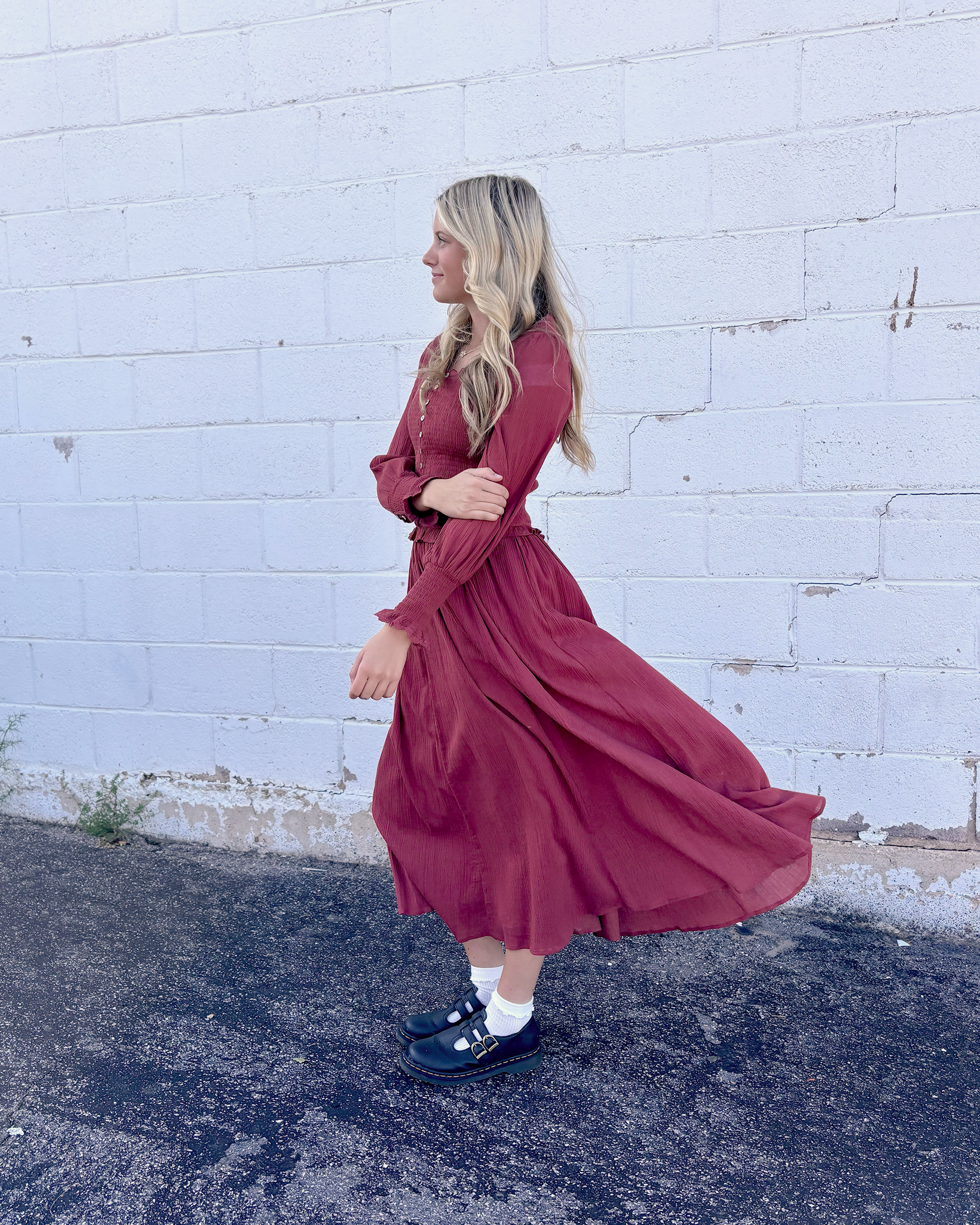 Rust colored dress with ruched bodice and long balloon sleeves and decorative buttons up the front and on the sleeve