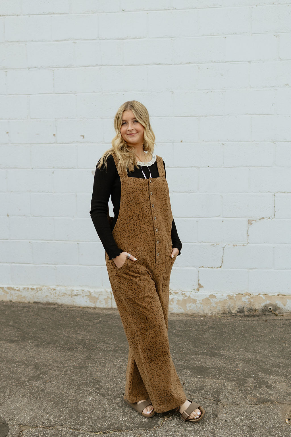 Overalls with a slight cheetah print and buttons up the front