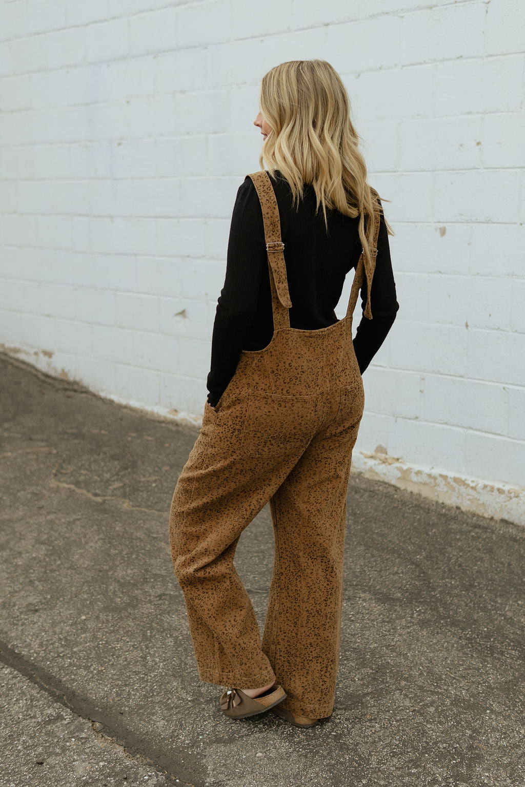 Overalls with a slight cheetah print and buttons up the front