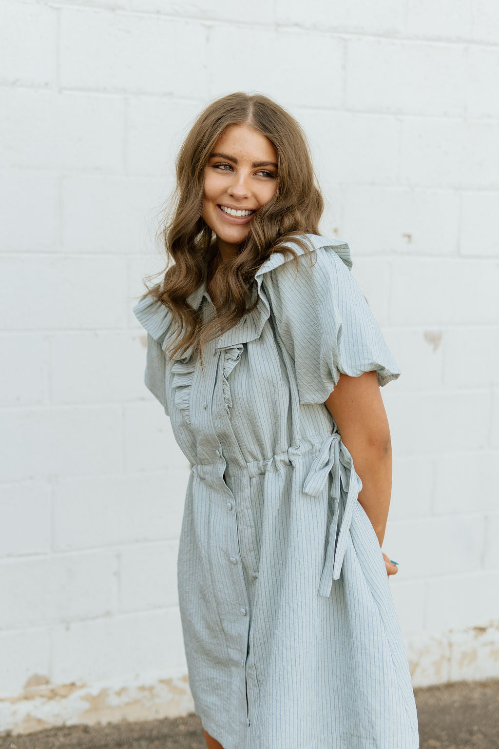 Light blue dress with two bow ties at the waist 