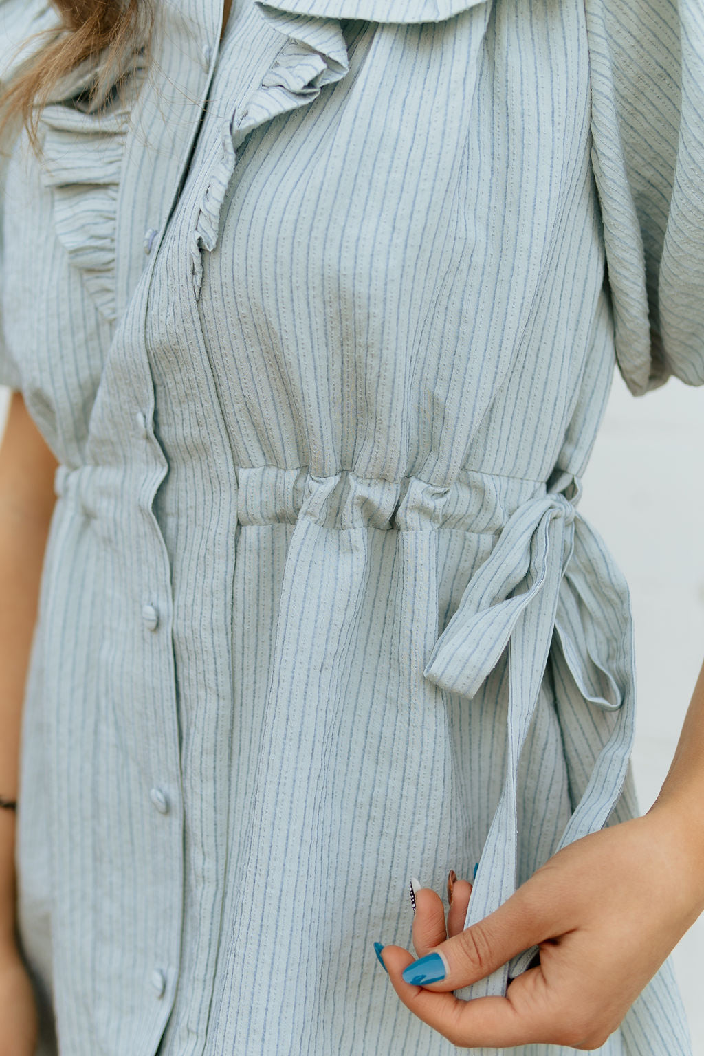 Light blue dress with two bow ties at the waist 