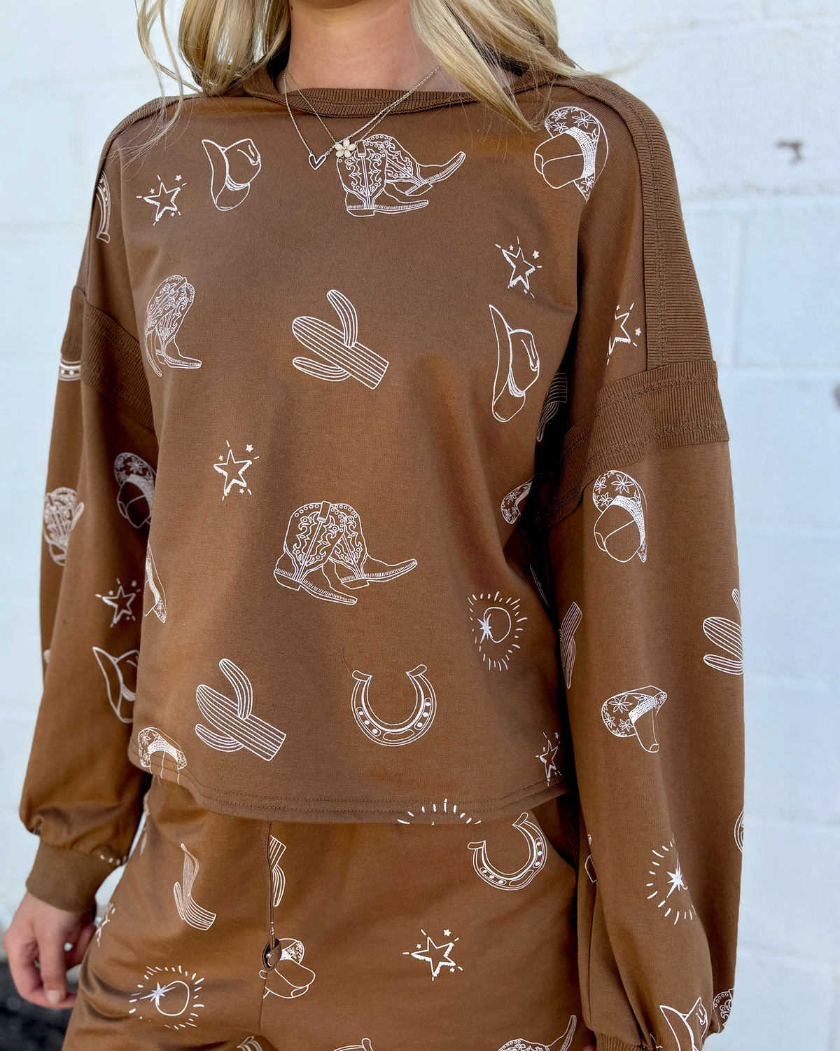 Brown outfit set with sweater top and shorts and cowboy icons all over