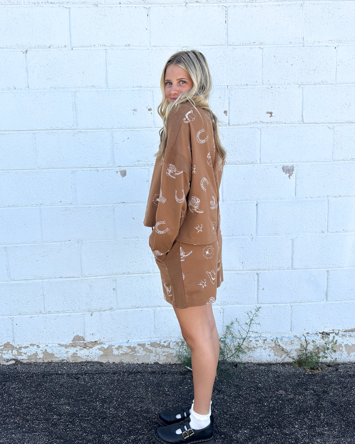 Brown outfit set with sweater top and shorts and cowboy icons all over