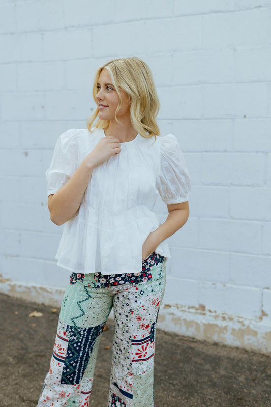 embroidered white shirt with pleats and puff sleeves
