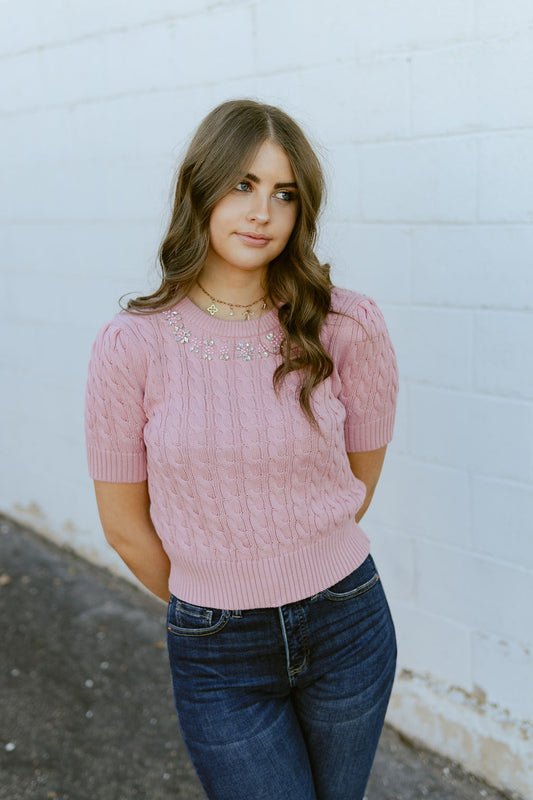 Pink cropped sweater with diamond details along the collar