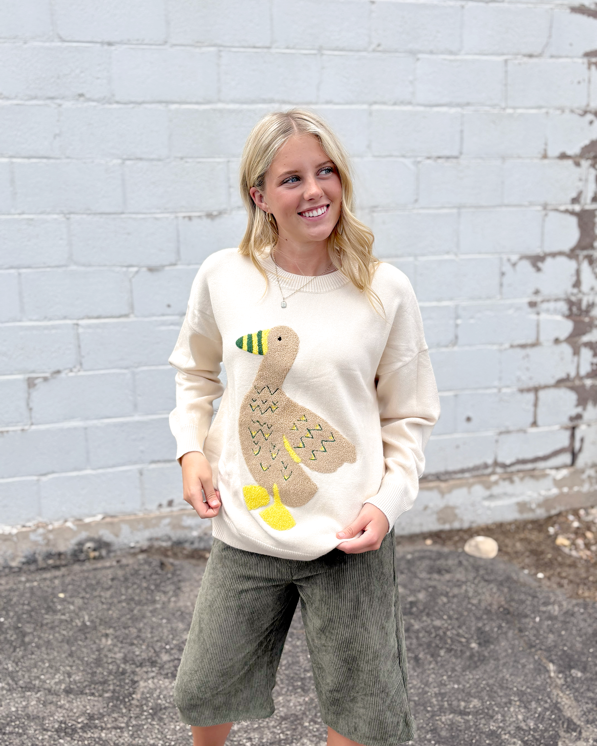 Ivory sweater with appliqué duck on the front