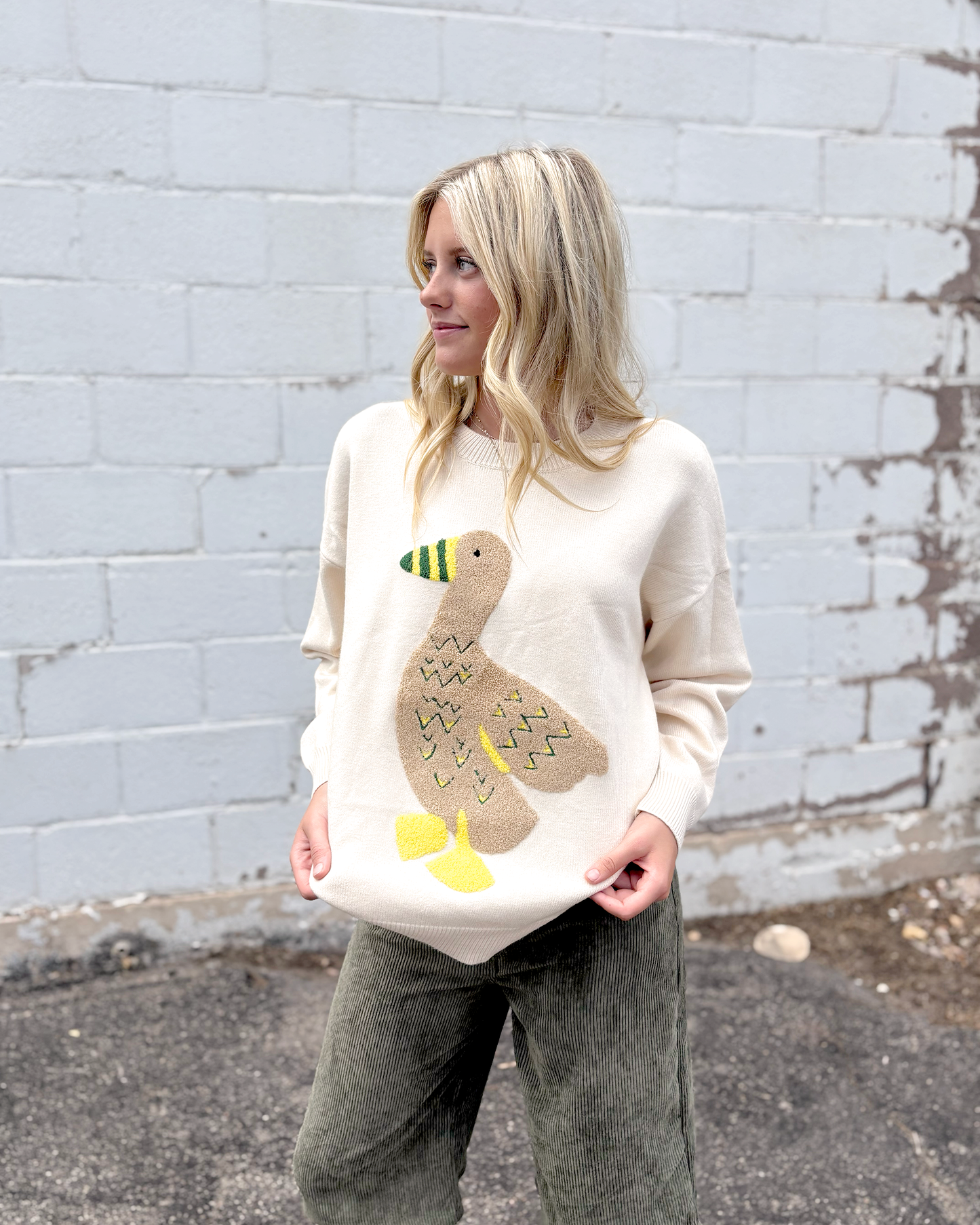 Ivory sweater with appliqué duck on the front