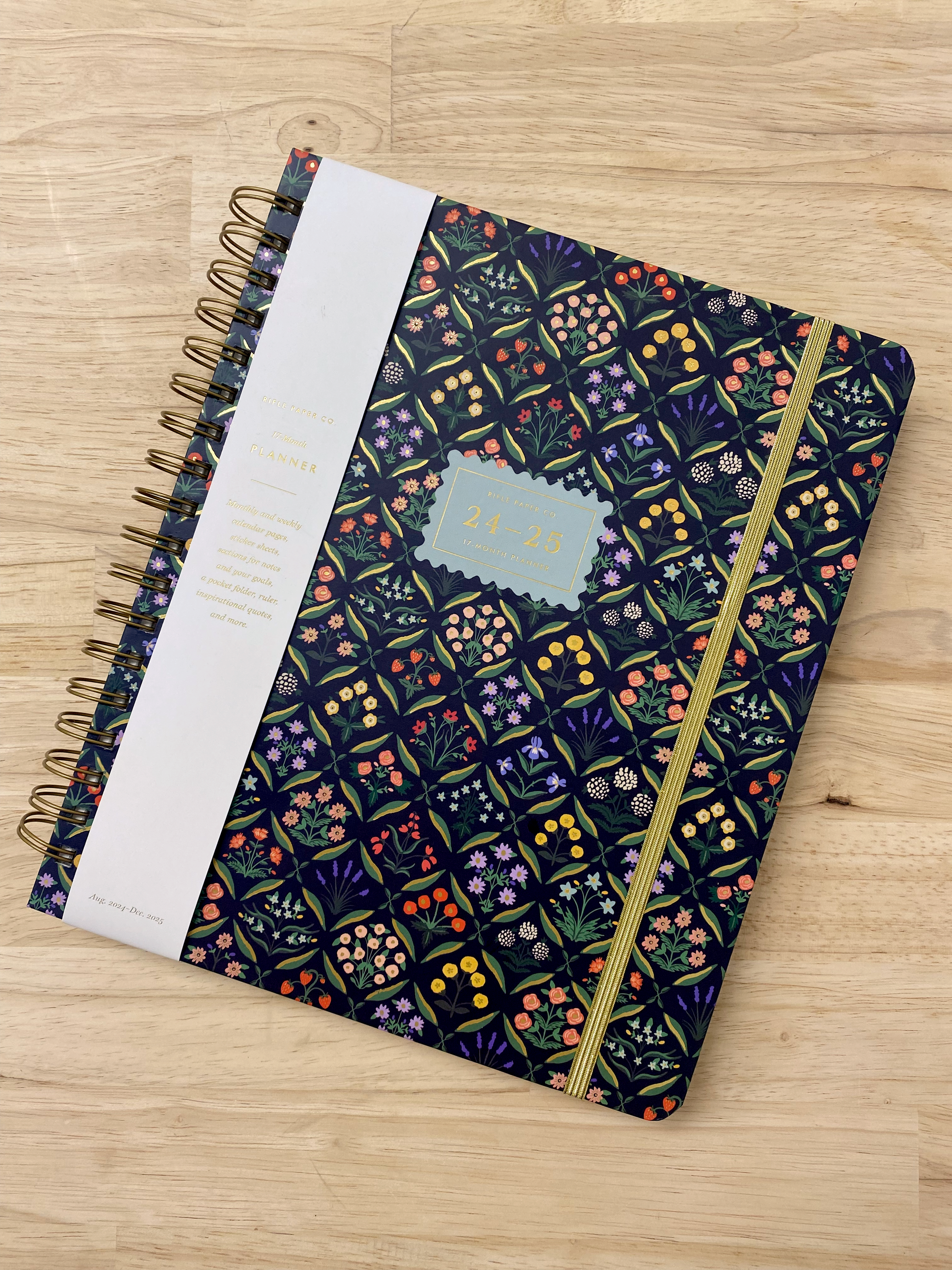 Rifle Paper Co 17-month planner with spiral binding, goals planner, sticker sheets, note pages, and a pocket folder