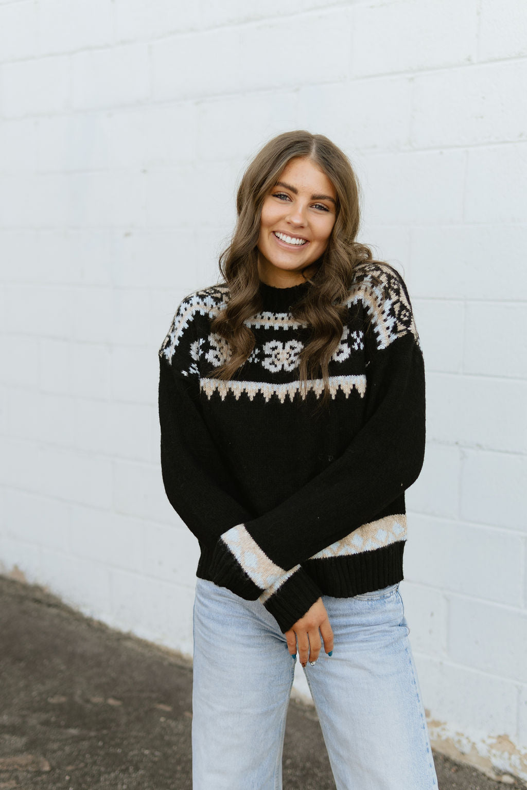 black sweater with fair isle design in ivory, tan and light blue