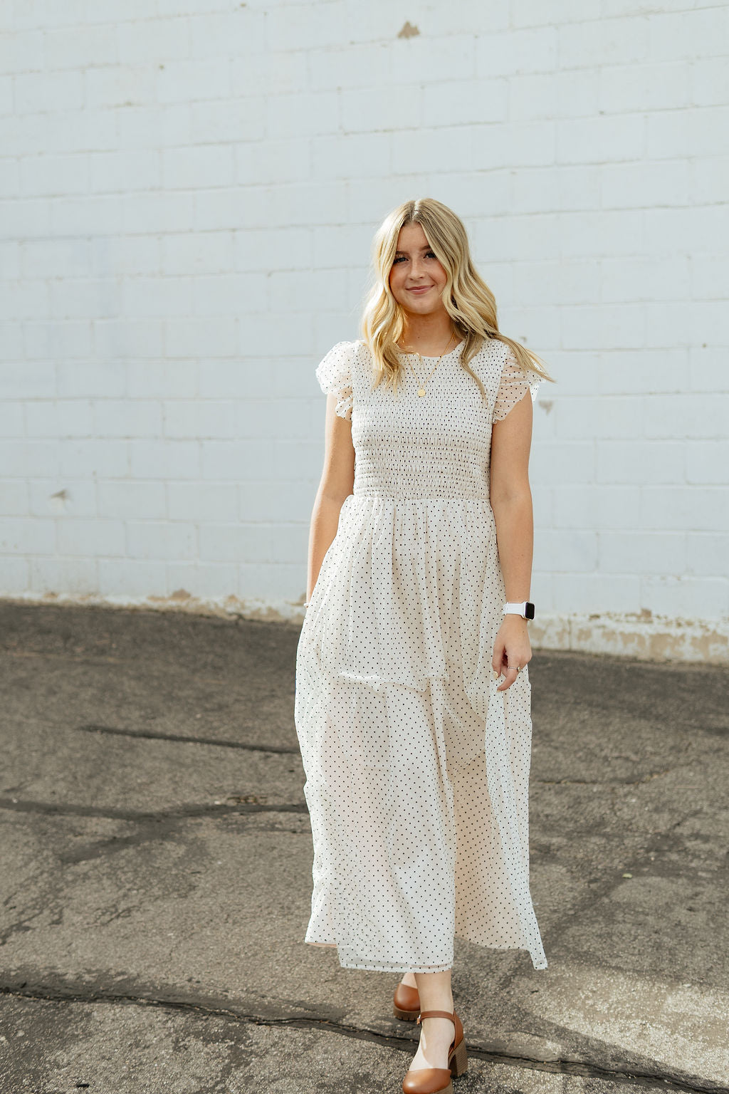 White dress with black polka dots and tulle details and flutter sleeves