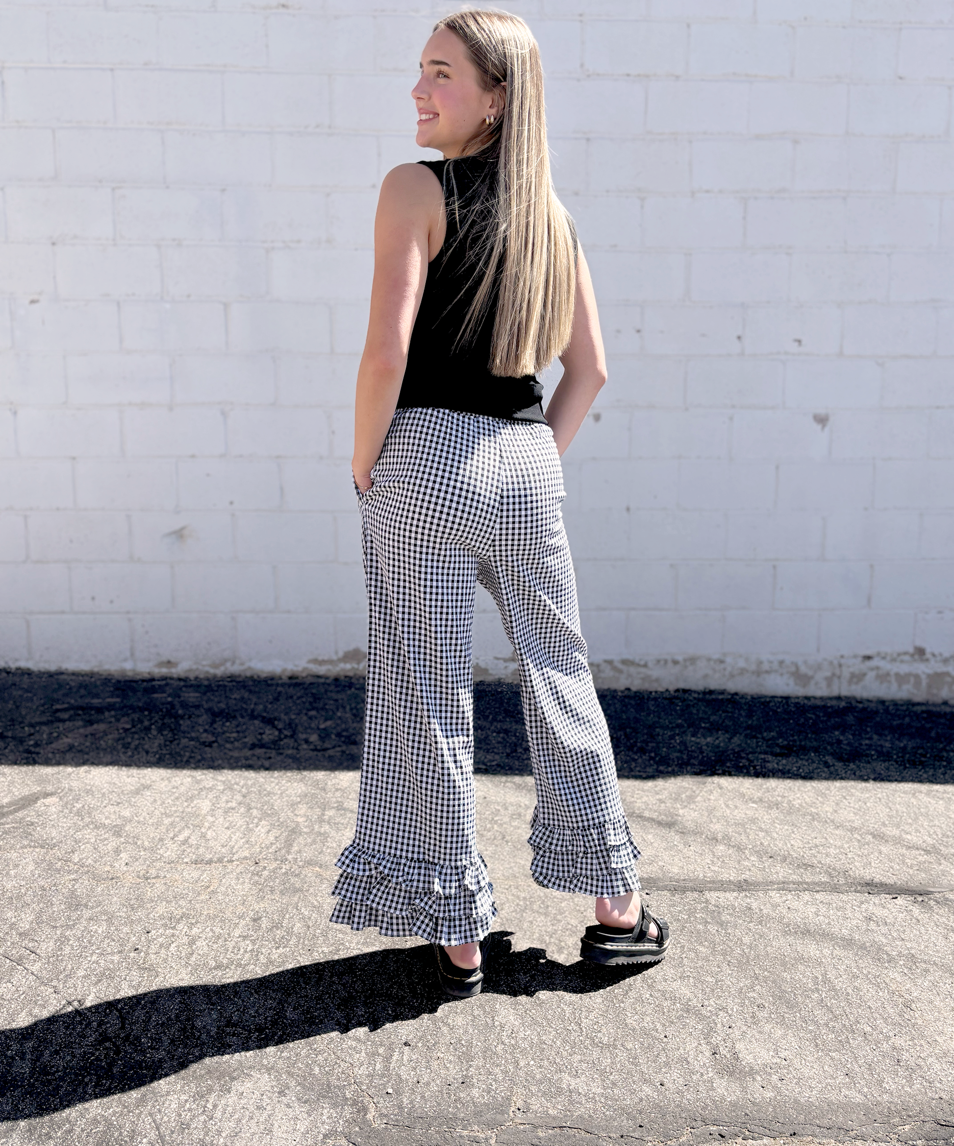 Black and white gingham pants with ruffles along the bottom of each leg