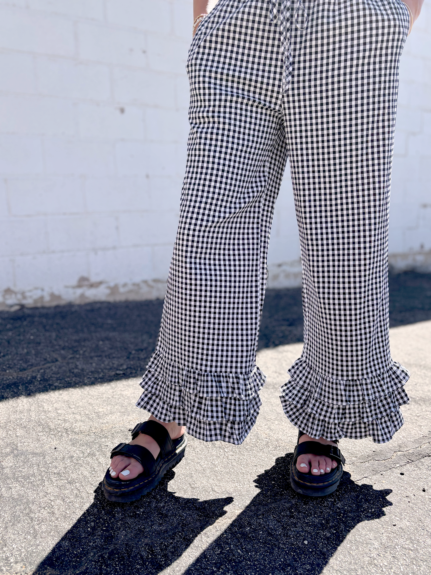 Black and white gingham pants with ruffles along the bottom of each leg