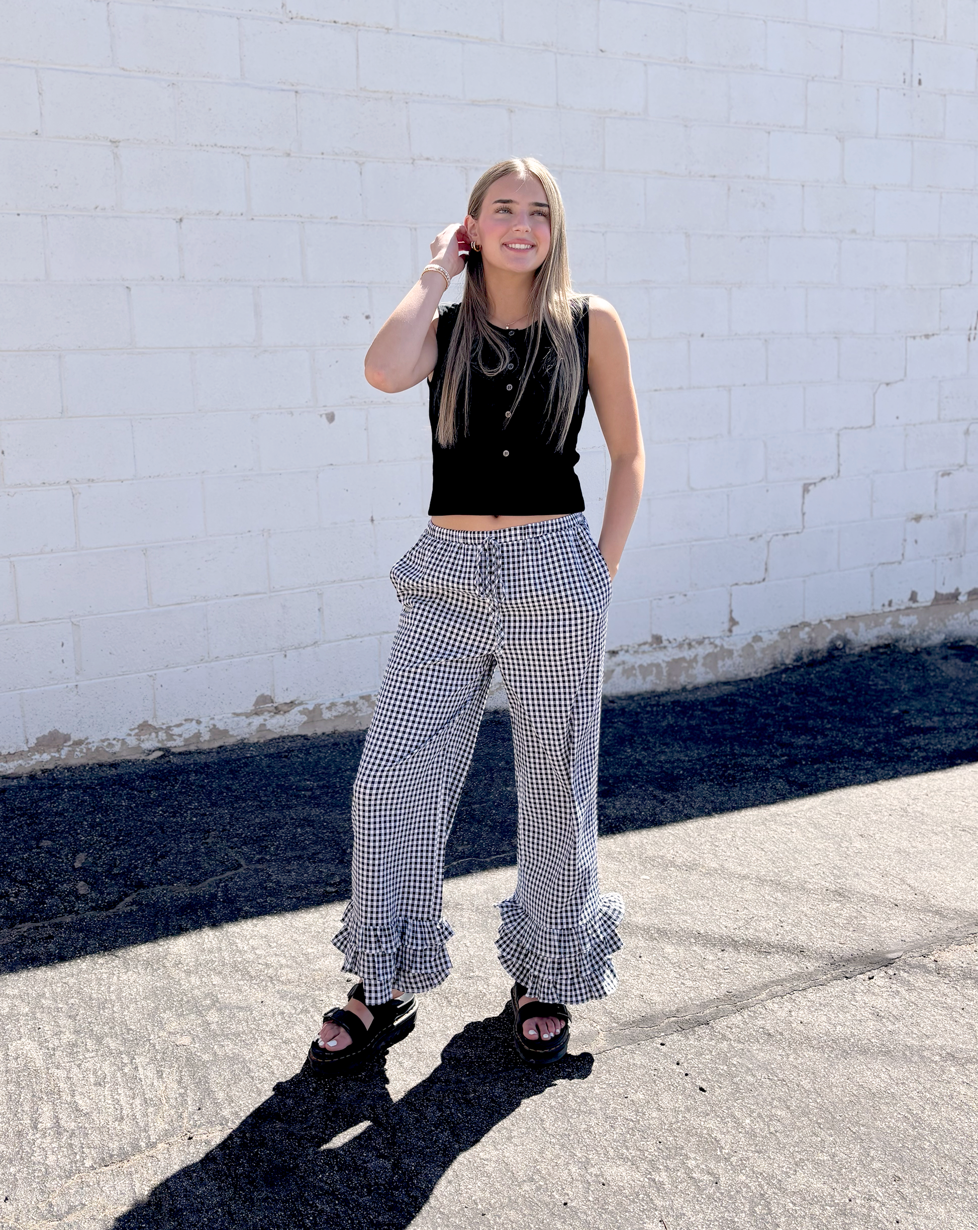 Black and white gingham pants with ruffles along the bottom of each leg